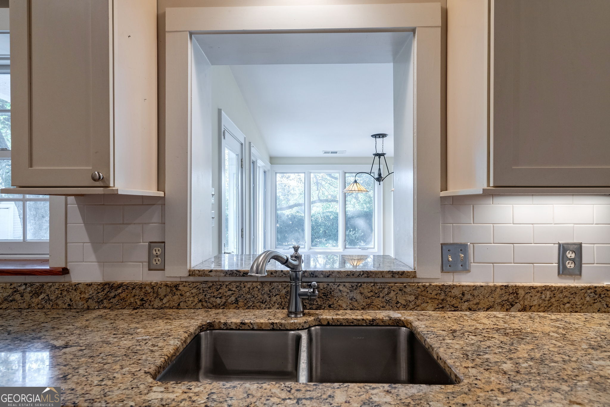 1761 Farmington Road Madison, GA 30650 - Photo 13 of 61 a kitchen with granite countertop a sink and a stove