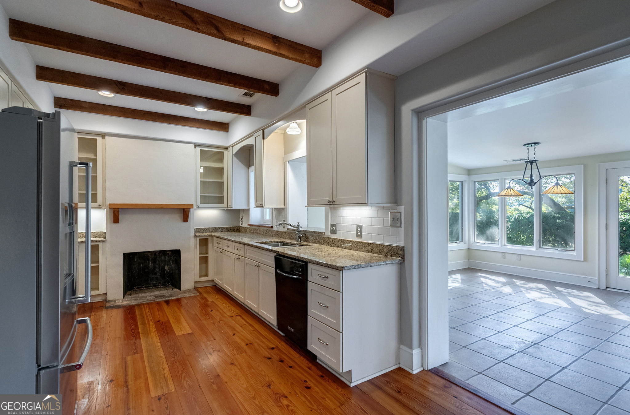 1761 Farmington Road Madison, GA 30650 - Photo 14 of 61 a kitchen with a stove and a wooden floors