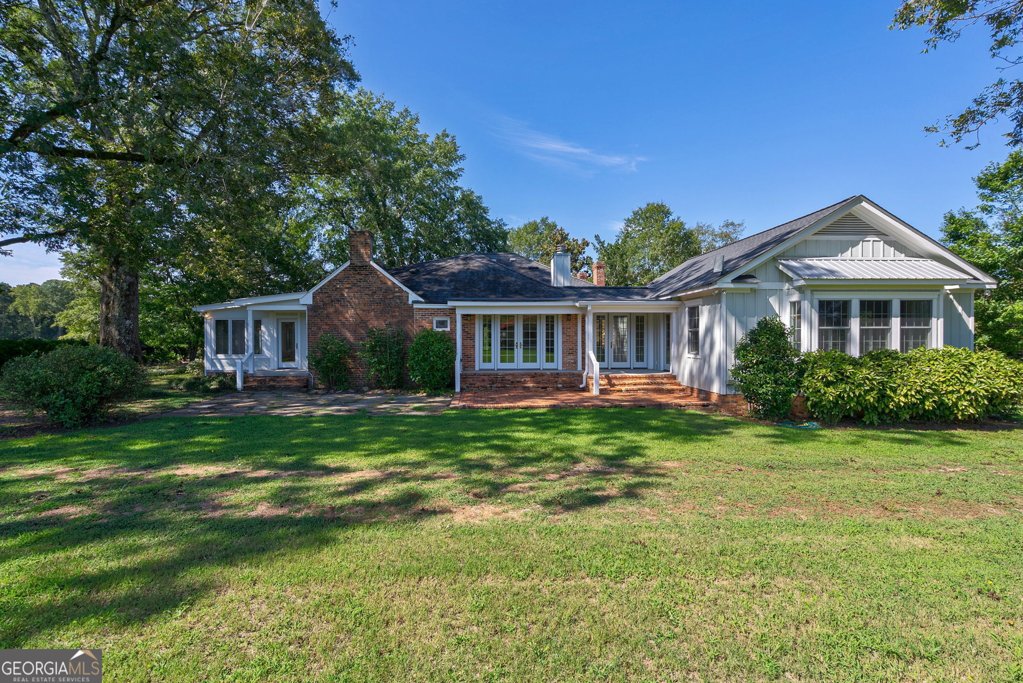 1761 Farmington Road Madison, GA 30650 - Photo 34 of 61 a front view of a house with a garden