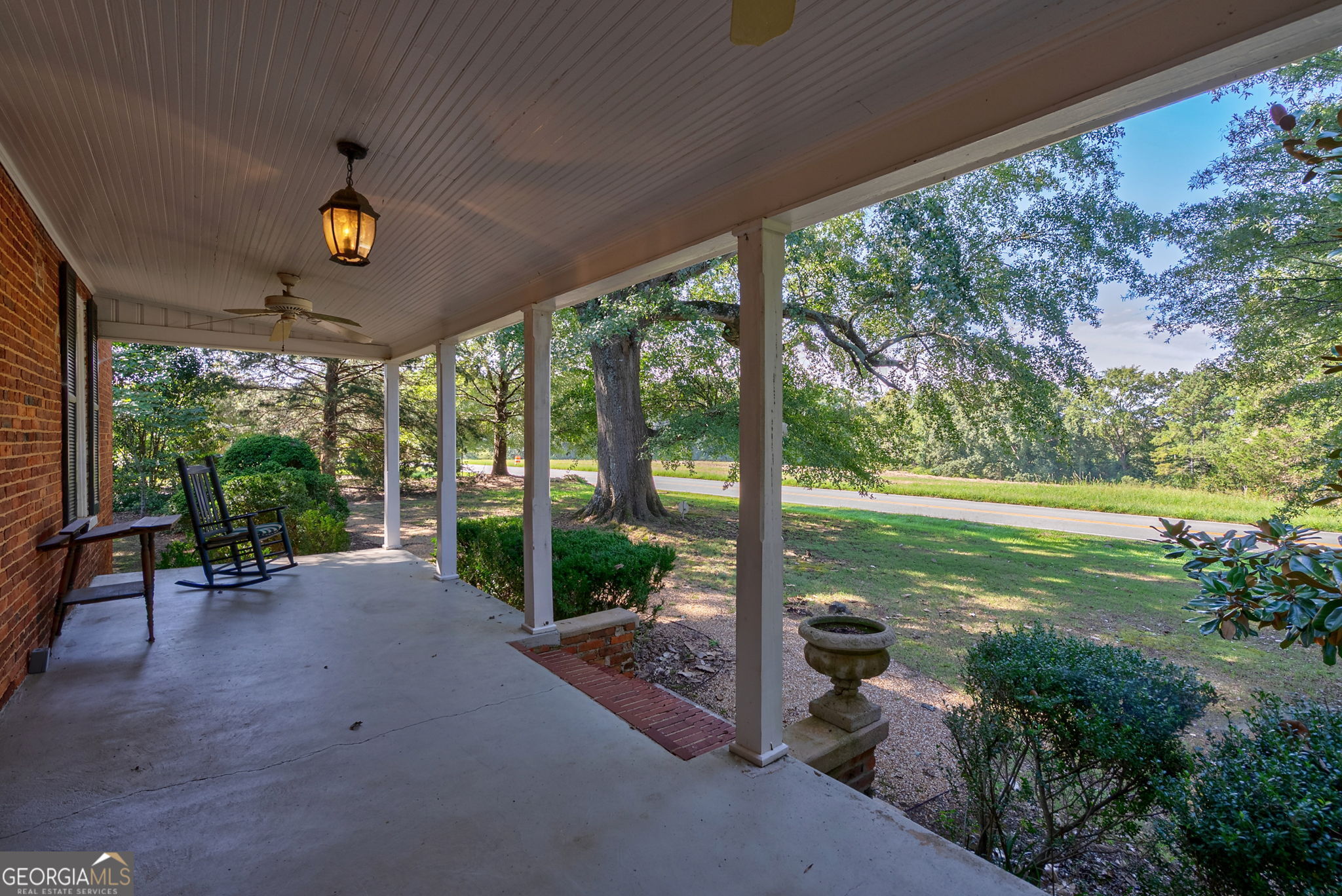 1761 Farmington Road Madison, GA 30650 - Photo 37 of 61 a view of a porch with chairs and a yard