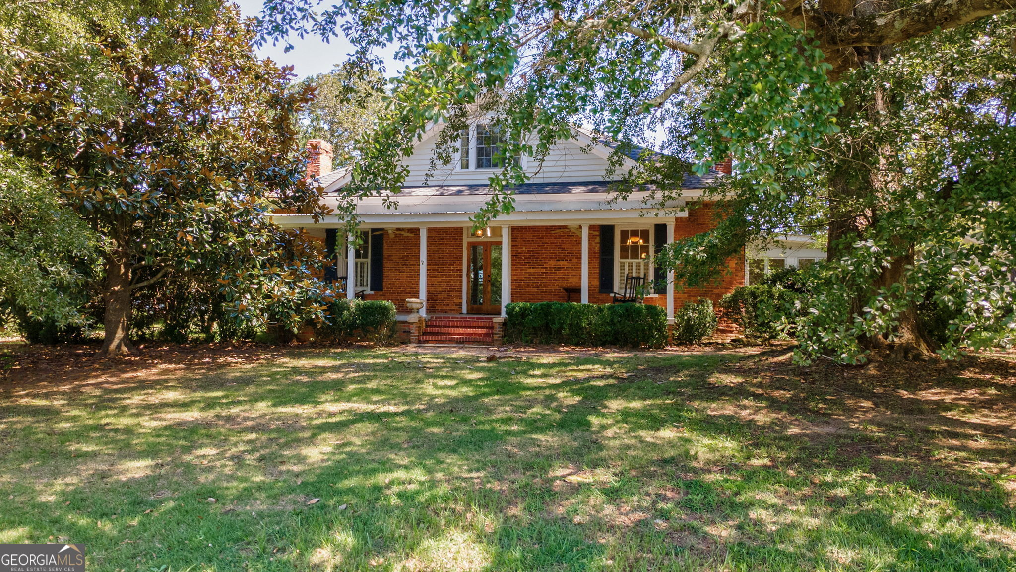 1761 Farmington Road Madison, GA 30650 - Photo 4 of 61 a front view of house with yard and trees around
