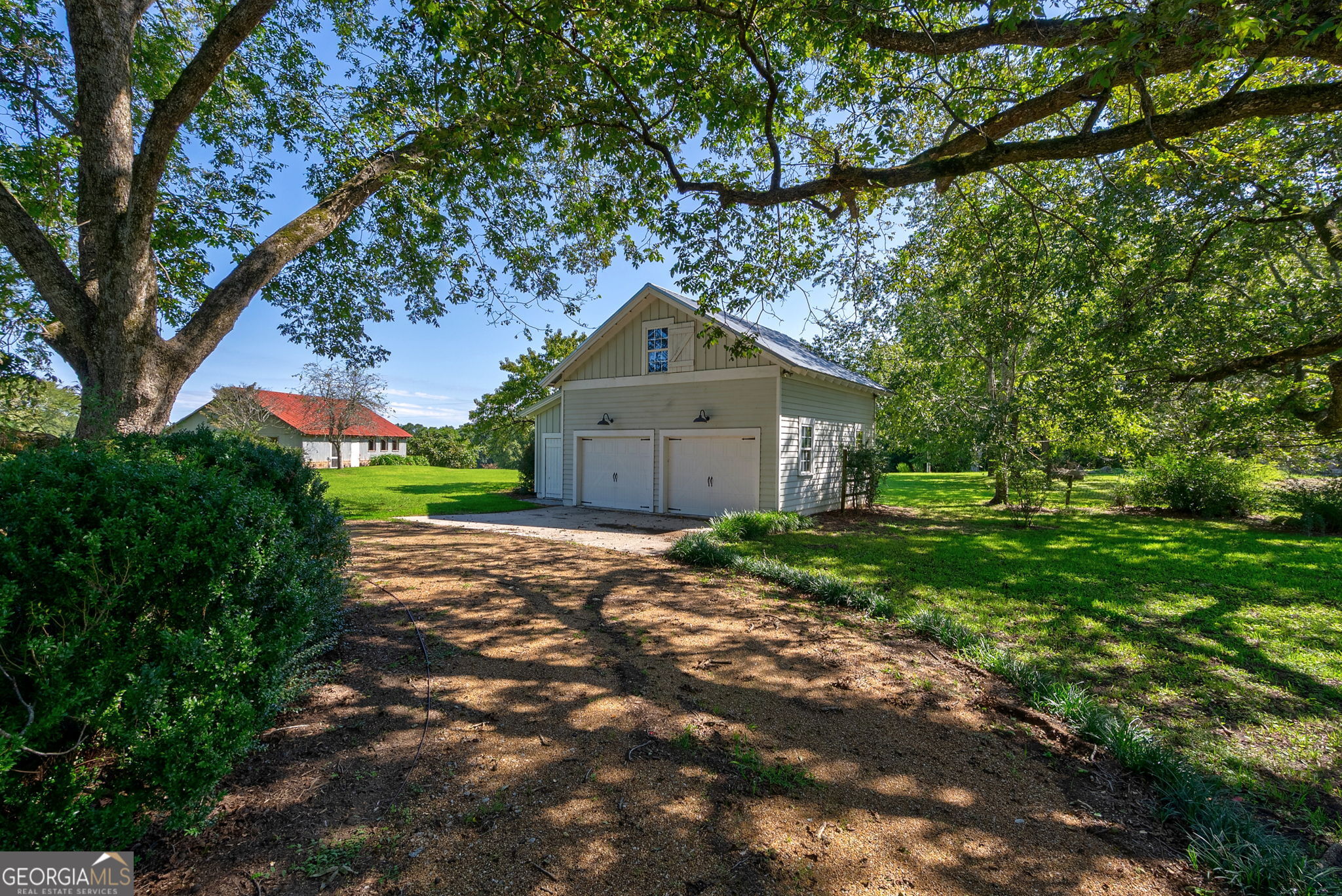 1761 Farmington Road Madison, GA 30650 - Photo 56 of 61 a front view of a house with a yard and trees