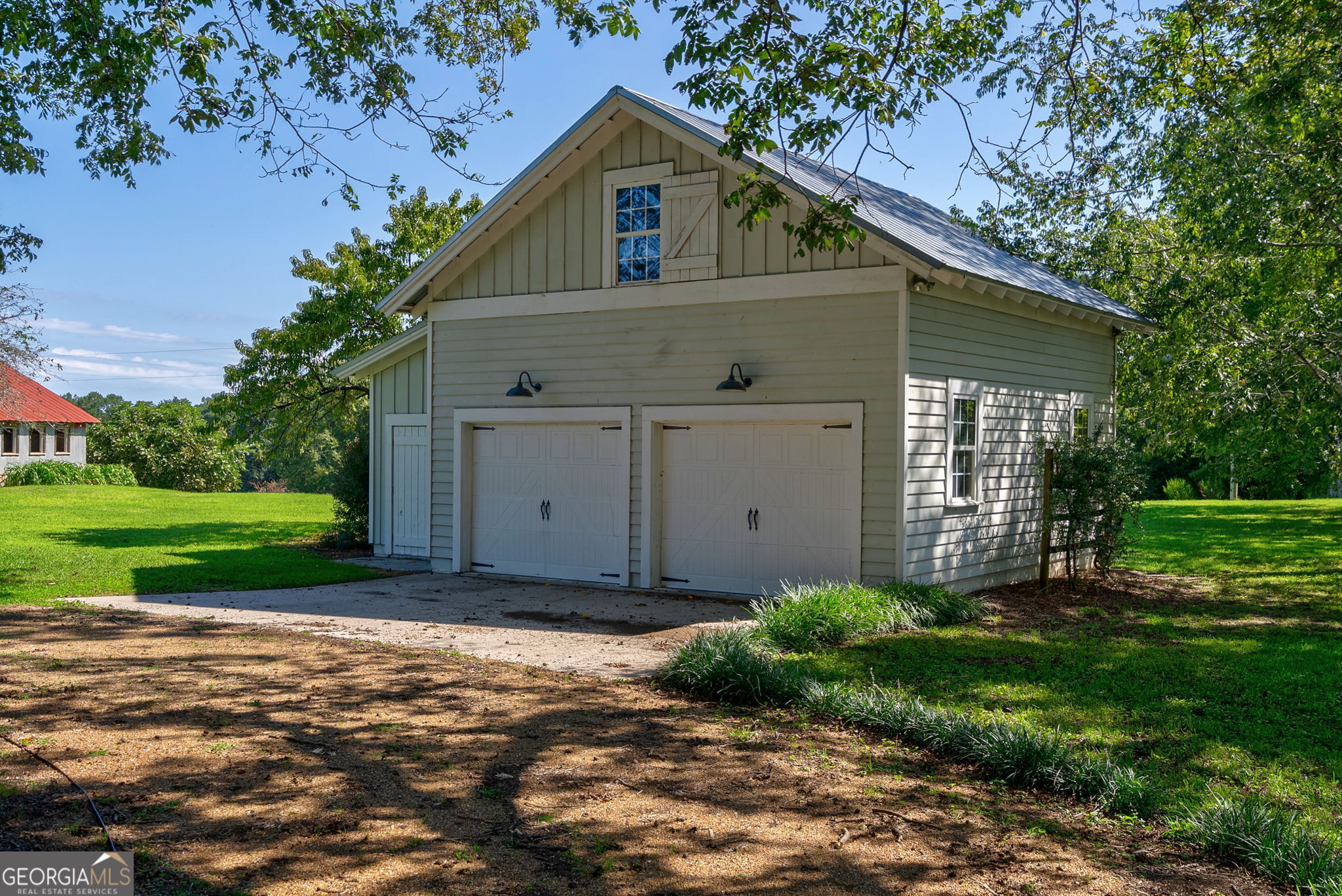 1761 Farmington Road Madison, GA 30650 - Photo 60 of 61 a view of a house with a yard and potted plants