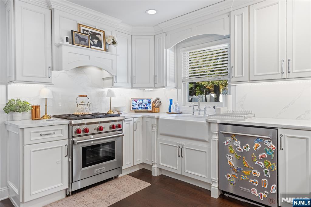 11 Robin Hood Way Wayne, NJ 07470 - Photo 13 of 36 a kitchen with stainless steel appliances a stove a sink and a microwave