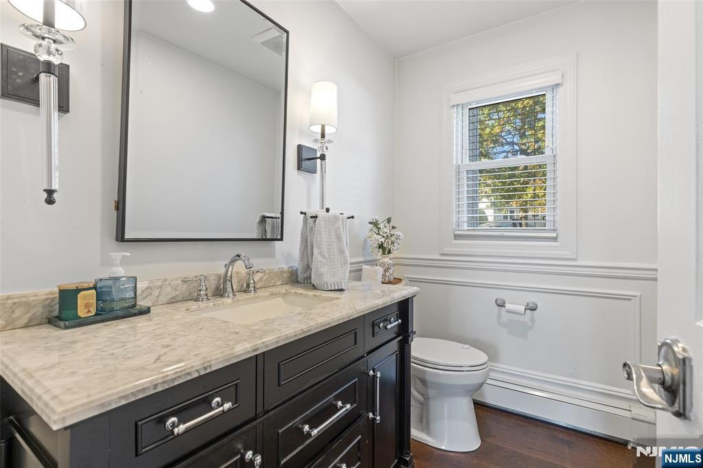11 Robin Hood Way Wayne, NJ 07470 - Photo 19 of 36 a bathroom with a granite countertop sink a toilet and a mirror
