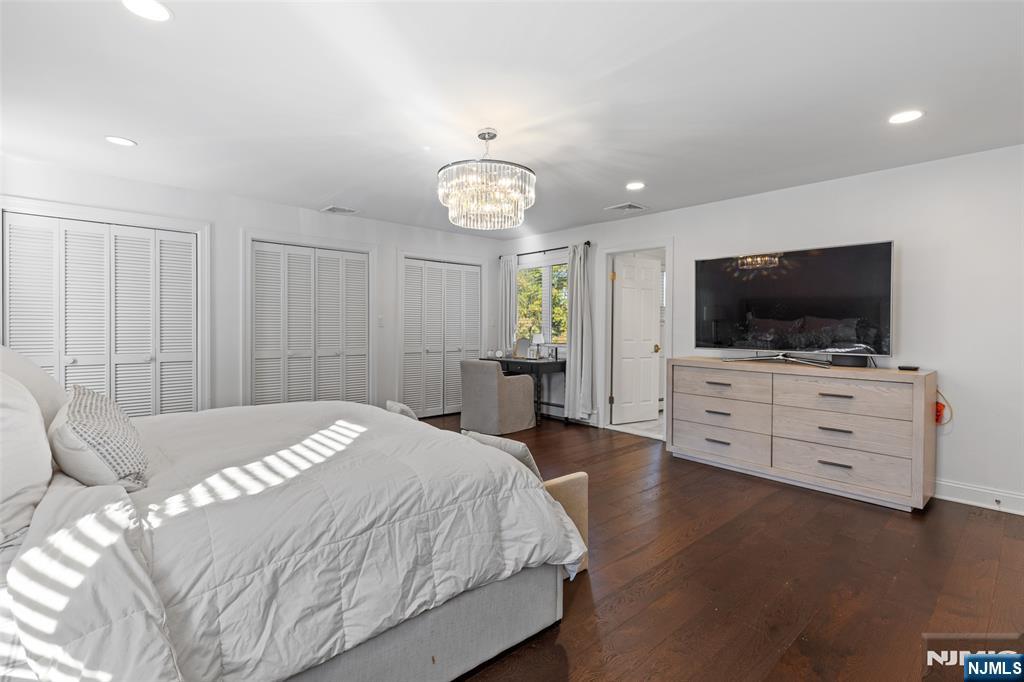 11 Robin Hood Way Wayne, NJ 07470 - Photo 22 of 36 a spacious bedroom with a bed and a flat screen tv