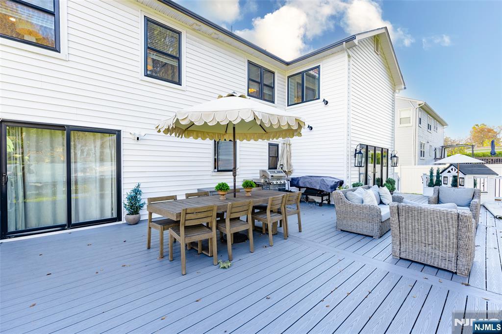 11 Robin Hood Way Wayne, NJ 07470 - Photo 28 of 36 a view of a dinning table and chairs in patio of the house