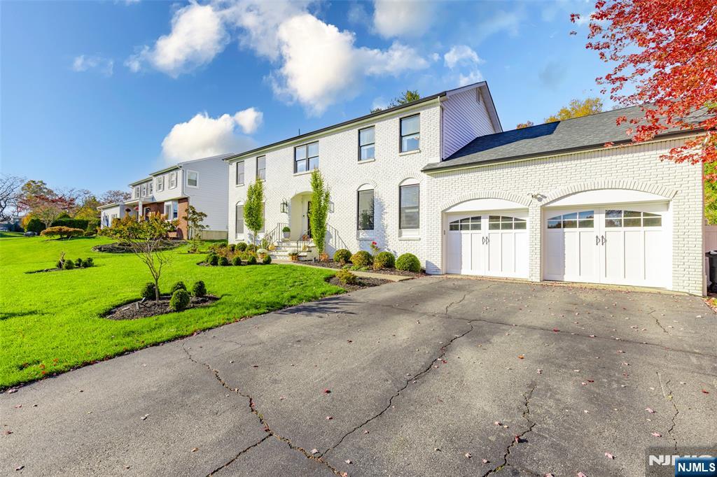 11 Robin Hood Way Wayne, NJ 07470 - Photo 4 of 36 a view of a white building among the side of a road