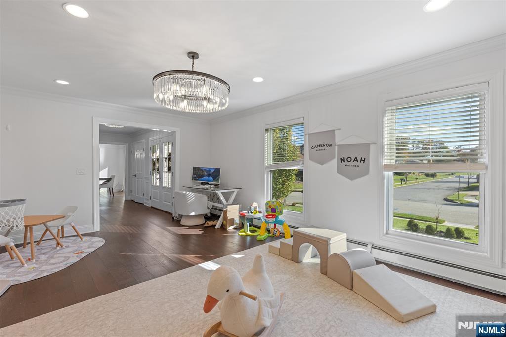 11 Robin Hood Way Wayne, NJ 07470 - Photo 8 of 36 a dining room with wooden floor and a chandelier