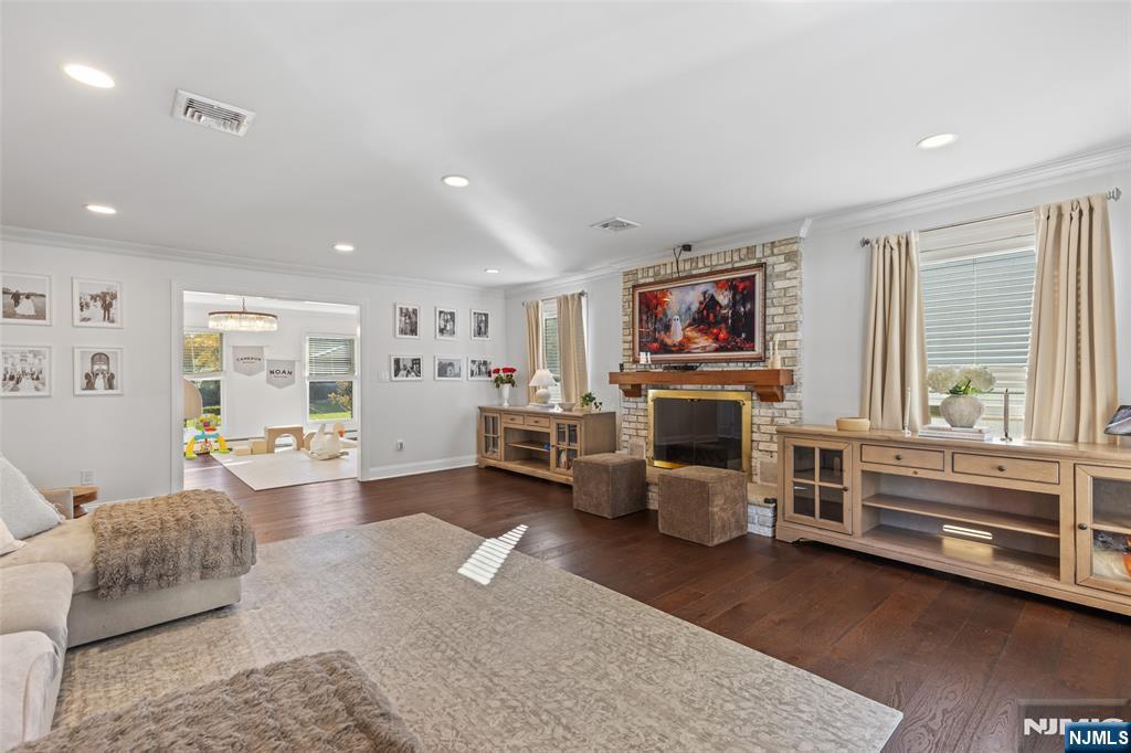 11 Robin Hood Way Wayne, NJ 07470 - Photo 10 of 36 a living room with furniture large window and fireplace