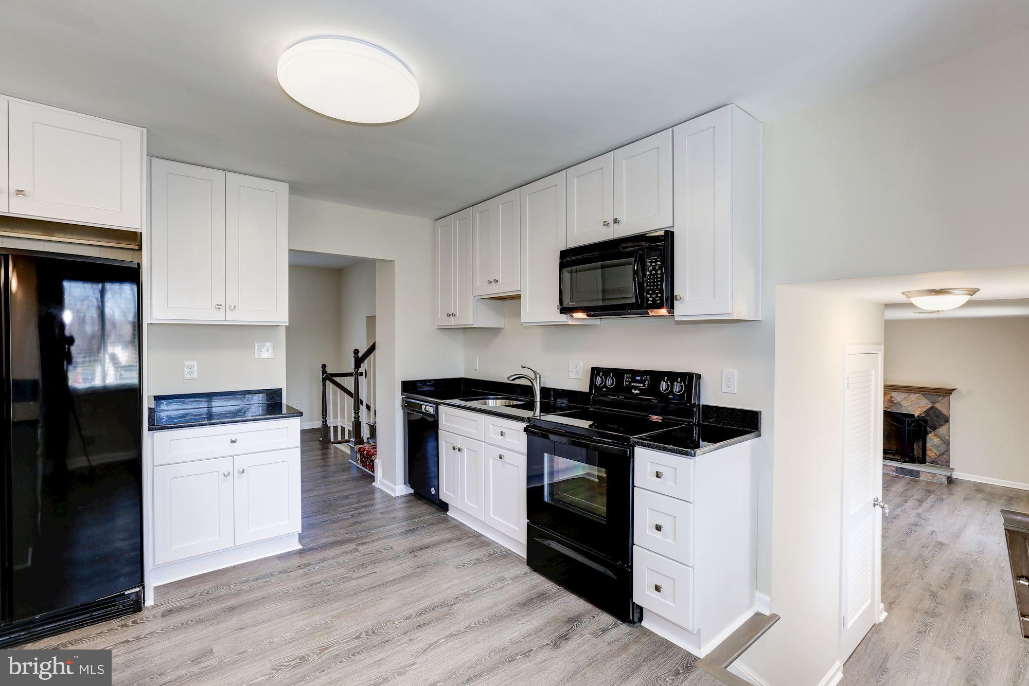 19608 Mosby Way Poolesville, MD 20837 - Photo 21 of 47 a kitchen with a stove top oven and sink
