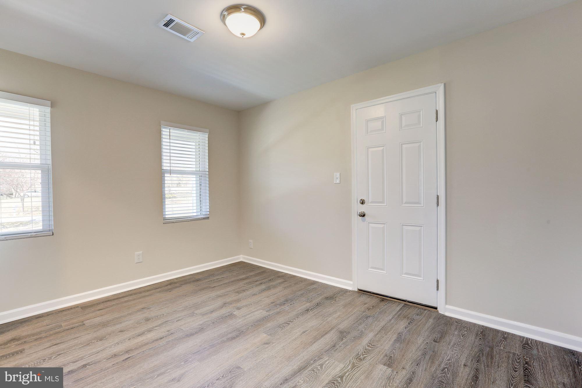 19608 Mosby Way Poolesville, MD 20837 - Photo 27 of 47 an empty room with wooden floor and windows