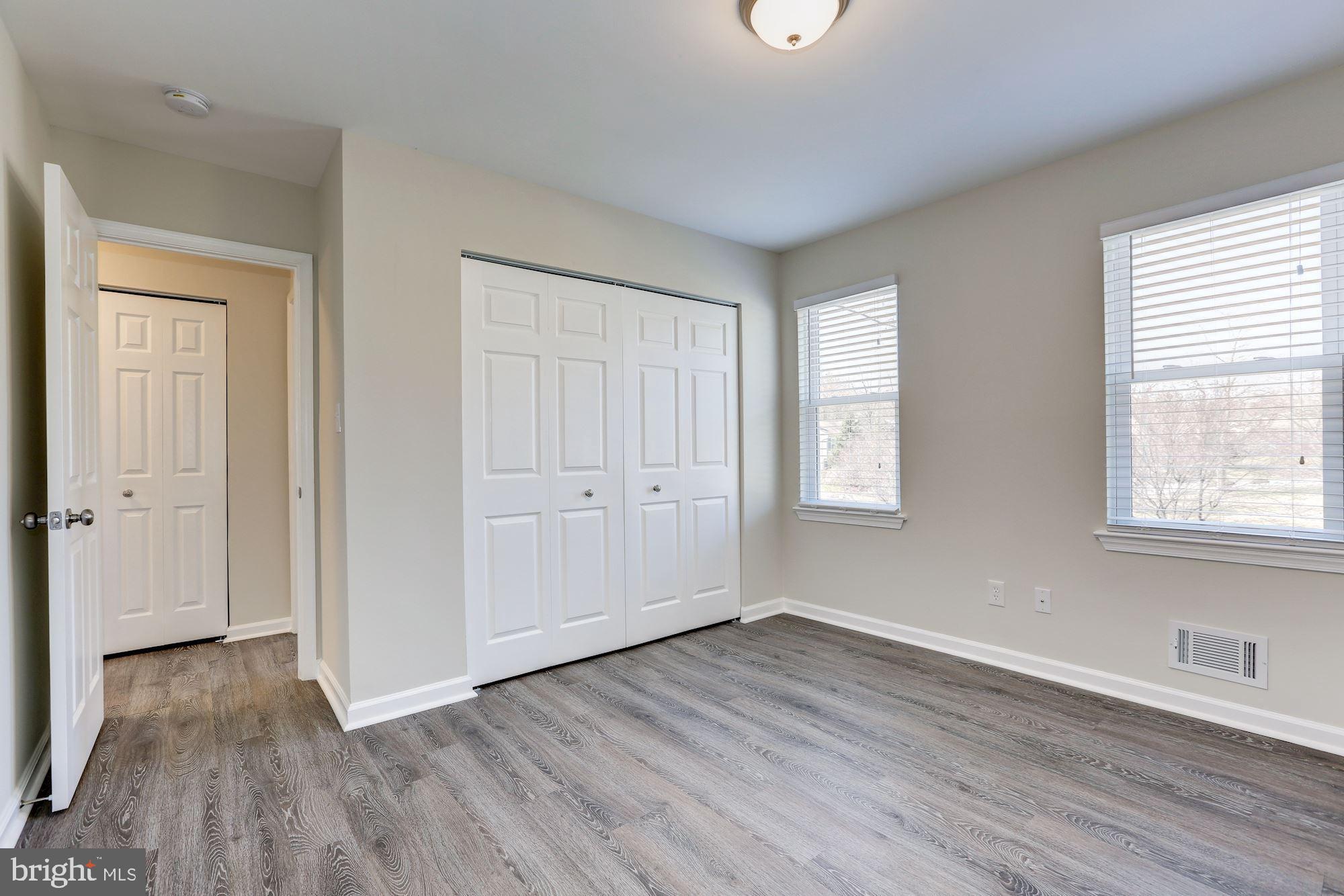 19608 Mosby Way Poolesville, MD 20837 - Photo 36 of 47 a view of an empty room with wooden floor and a window