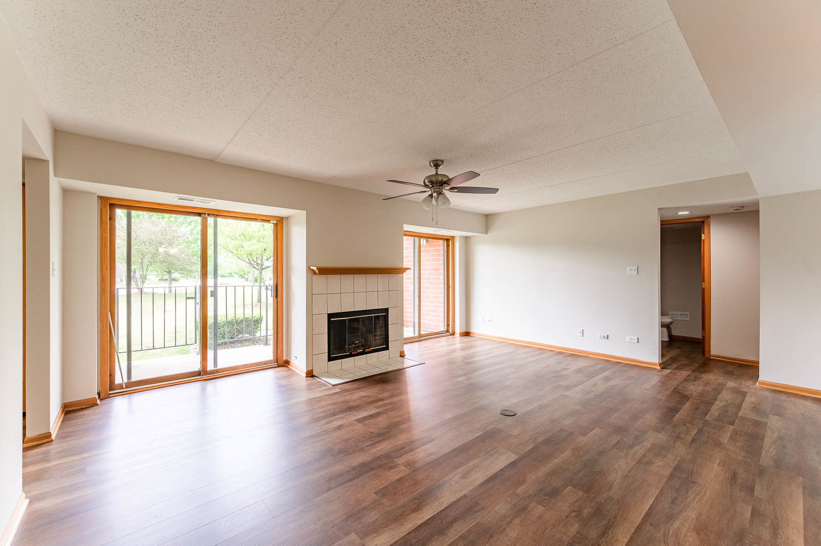 18136 Rita Road, Unit 1D Tinley Park, IL 60477 - Photo 3 of 11 a view of empty room with wooden floor and fireplace