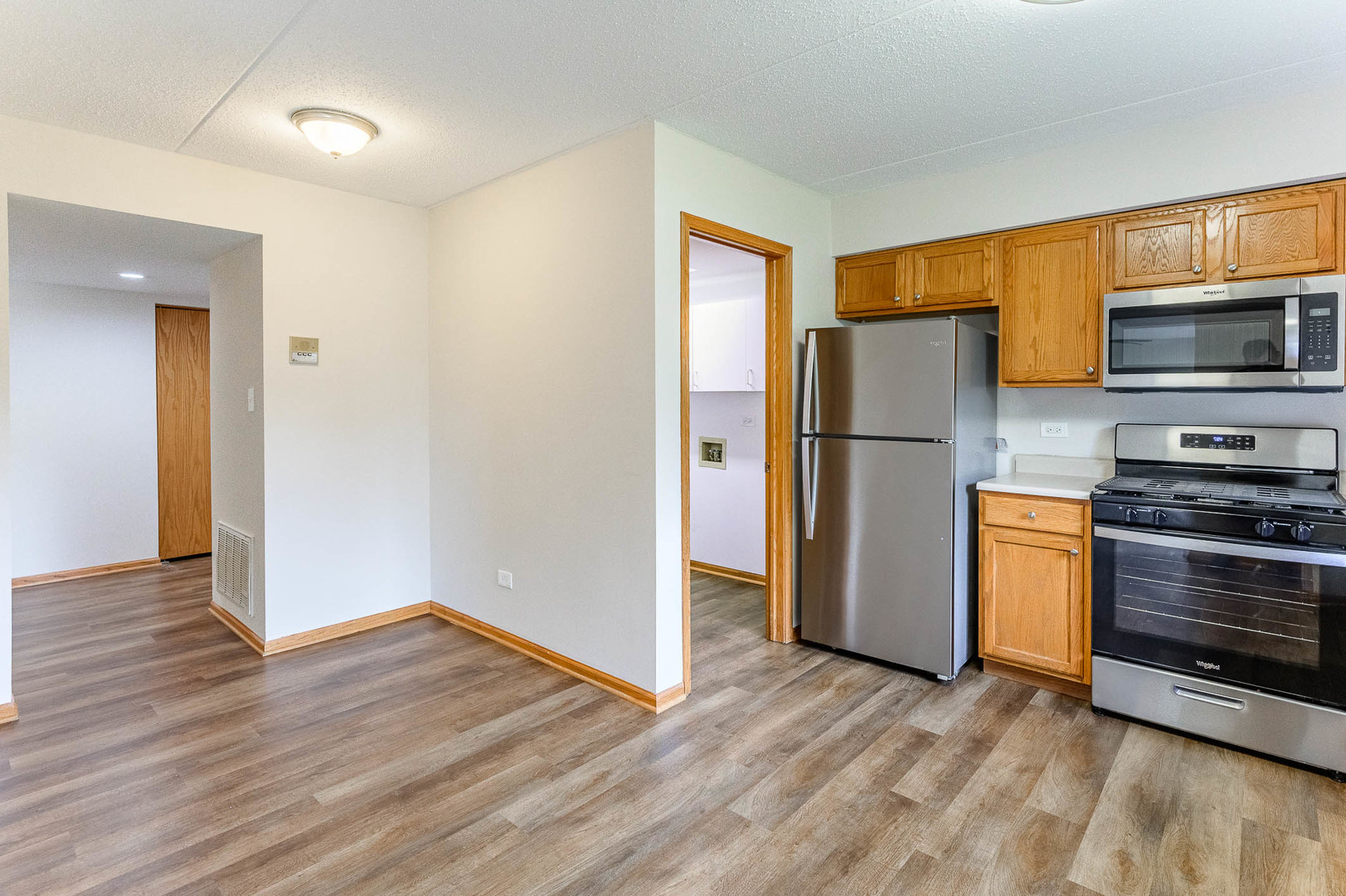 18136 Rita Road, Unit 1D Tinley Park, IL 60477 - Photo 5 of 11 a kitchen with a refrigerator and a stove top oven