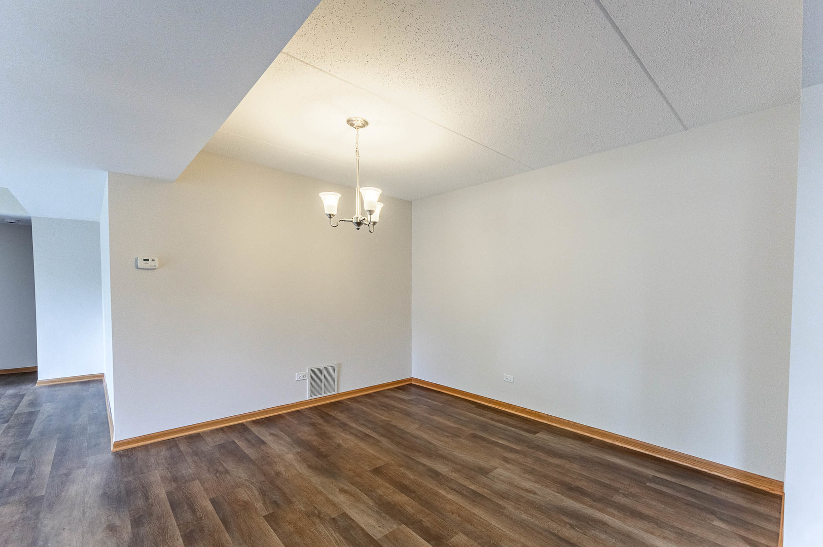 18136 Rita Road, Unit 1D Tinley Park, IL 60477 - Photo 6 of 11 wooden floor in an empty room with a window