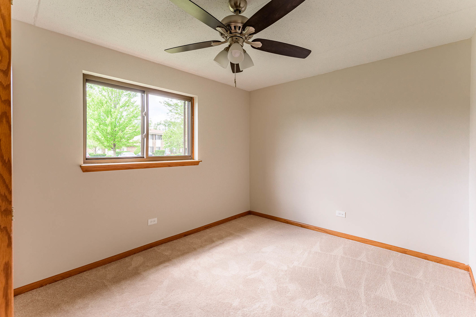 18136 Rita Road, Unit 1D Tinley Park, IL 60477 - Photo 7 of 11 an empty room with windows and fan