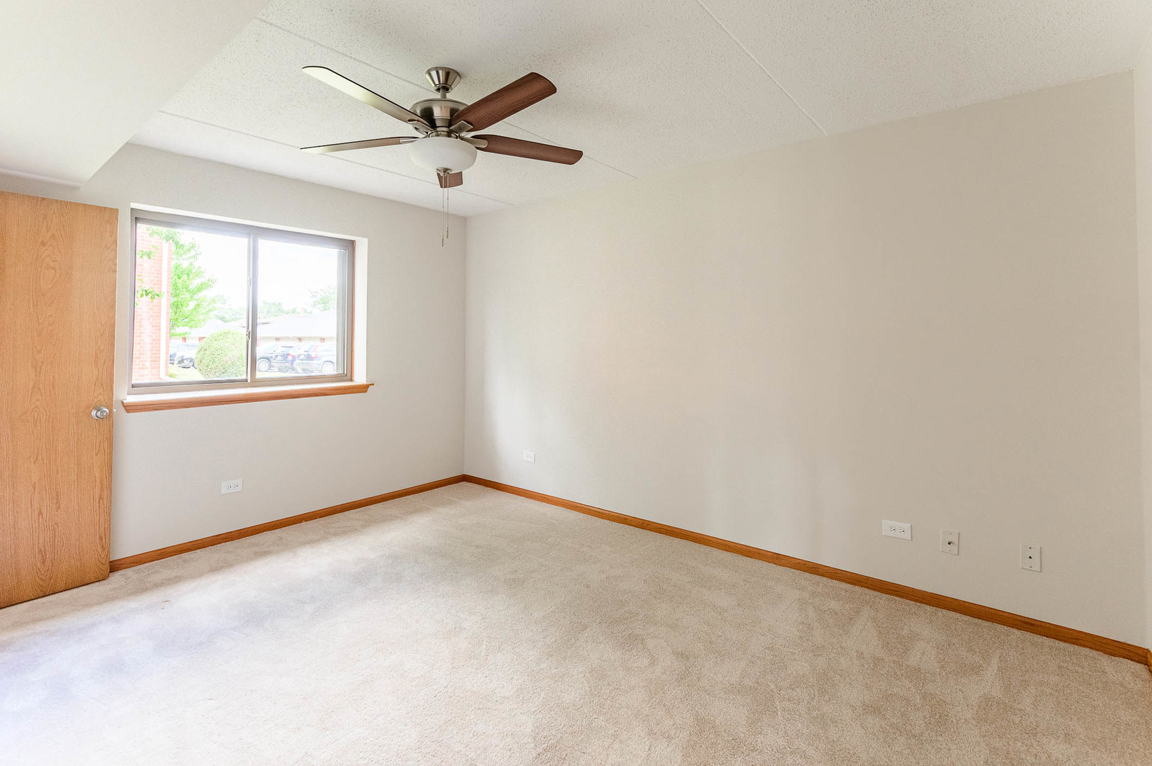 18136 Rita Road, Unit 1D Tinley Park, IL 60477 - Photo 8 of 11 an empty room with a window and a ceiling fan