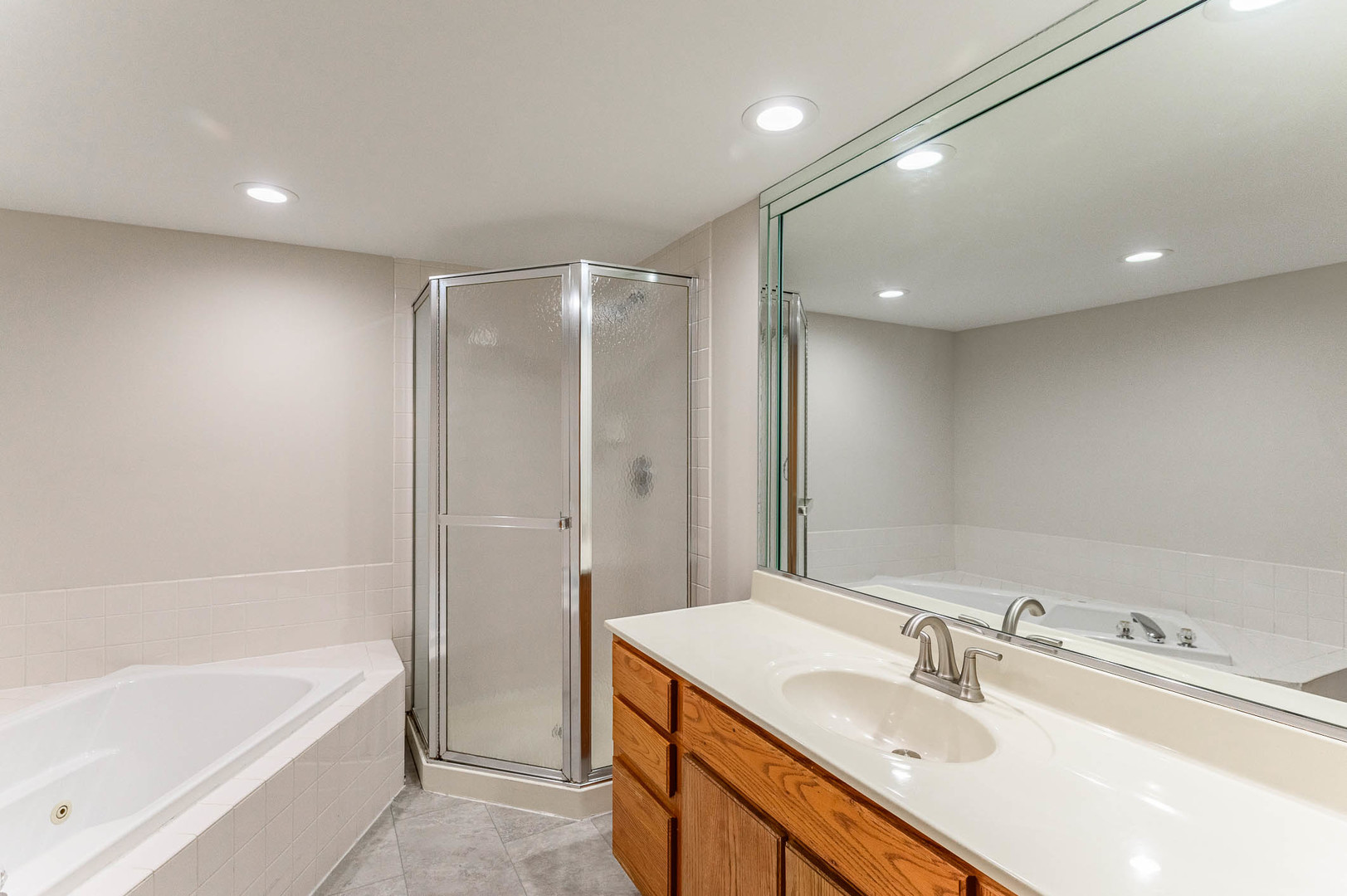 18136 Rita Road, Unit 1D Tinley Park, IL 60477 - Photo 10 of 11 a bathroom with a bathtub shower sink vanity and toilet
