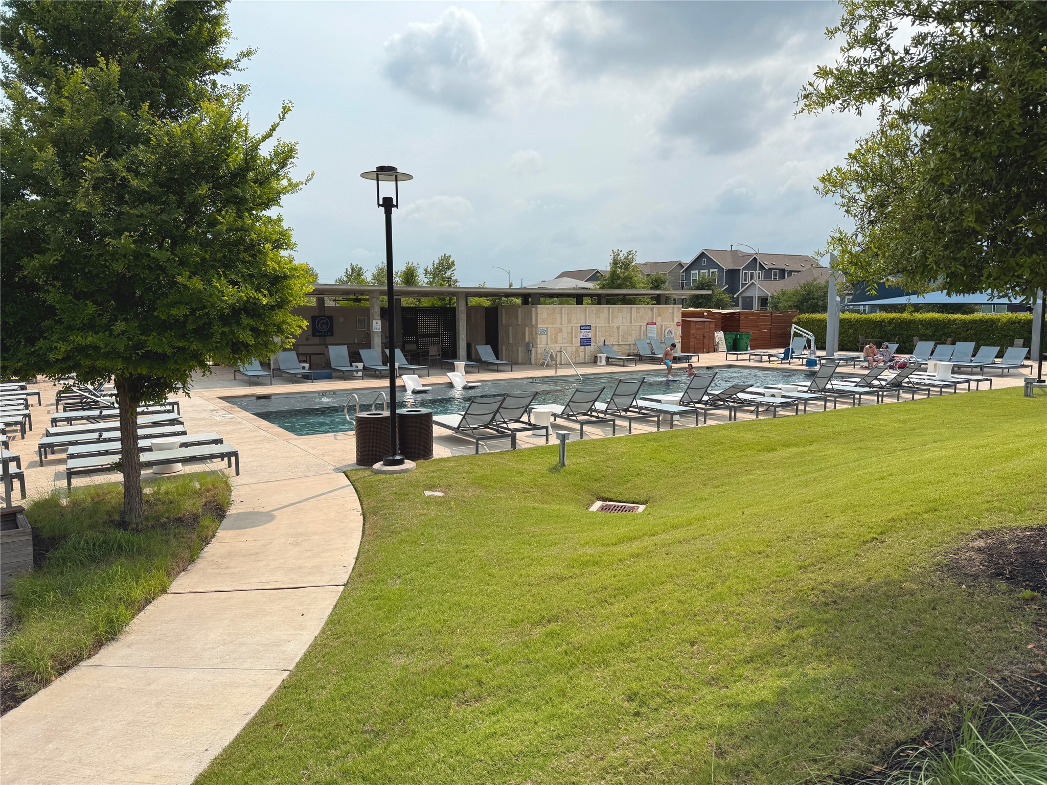 9015 Cattle Baron Path, Unit 605 Austin, TX 78747 - Photo 17 of 20 Surrounding community with a lawn, a patio, and a swimming pool