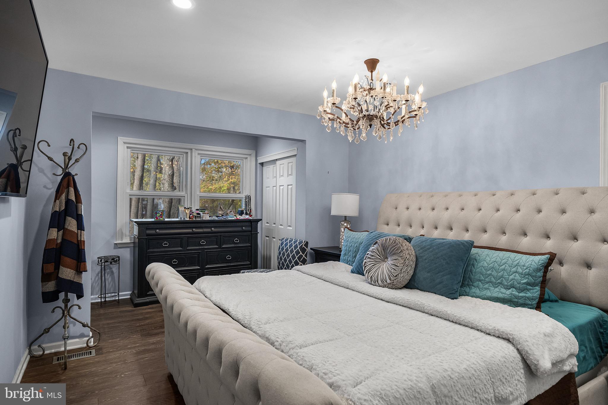 155 Tuckerton Road Medford Lakes, NJ 08055 - Photo 19 of 48 a bedroom with a bed and a chandelier