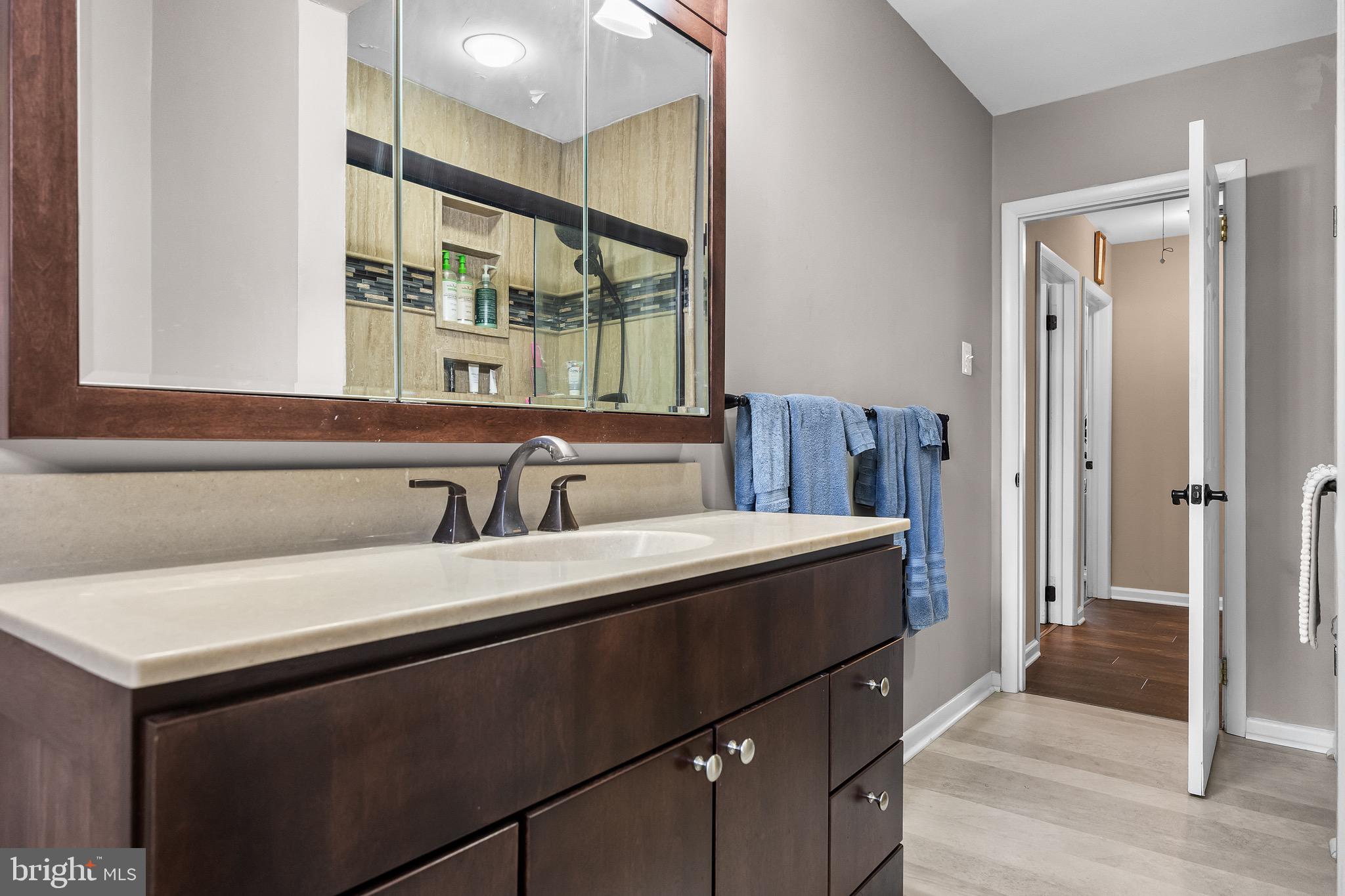 155 Tuckerton Road Medford Lakes, NJ 08055 - Photo 23 of 48 a hallway with a sink and a mirror