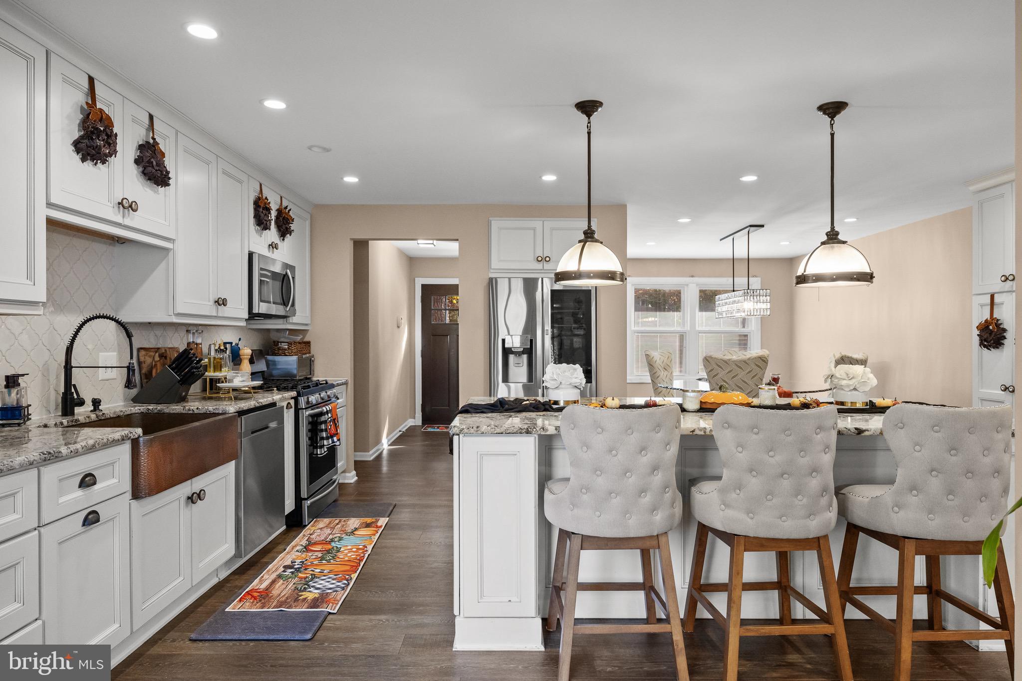 155 Tuckerton Road Medford Lakes, NJ 08055 - Photo 7 of 48 a large kitchen with sink a refrigerator and chairs