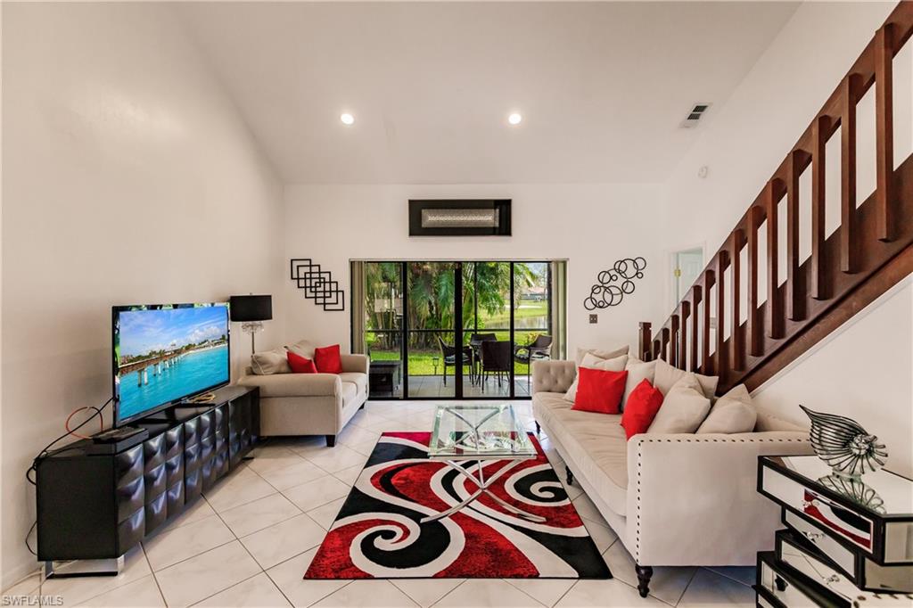 Undisclosed Address Naples, FL 34113 - Photo 1 of 24 a living room with furniture and a flat screen tv