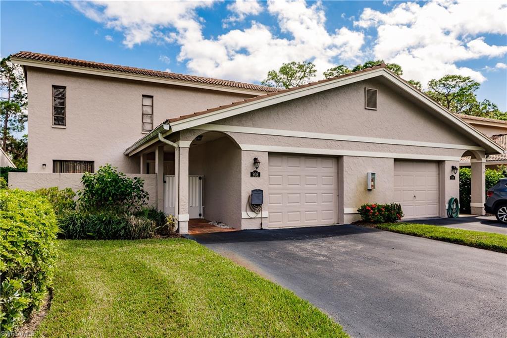 Undisclosed Address Naples, FL 34113 - Photo 2 of 24 a front view of house with yard