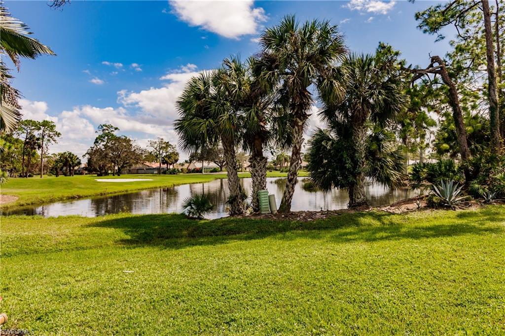 Undisclosed Address Naples, FL 34113 - Photo 22 of 24 a view of a lake with a yard