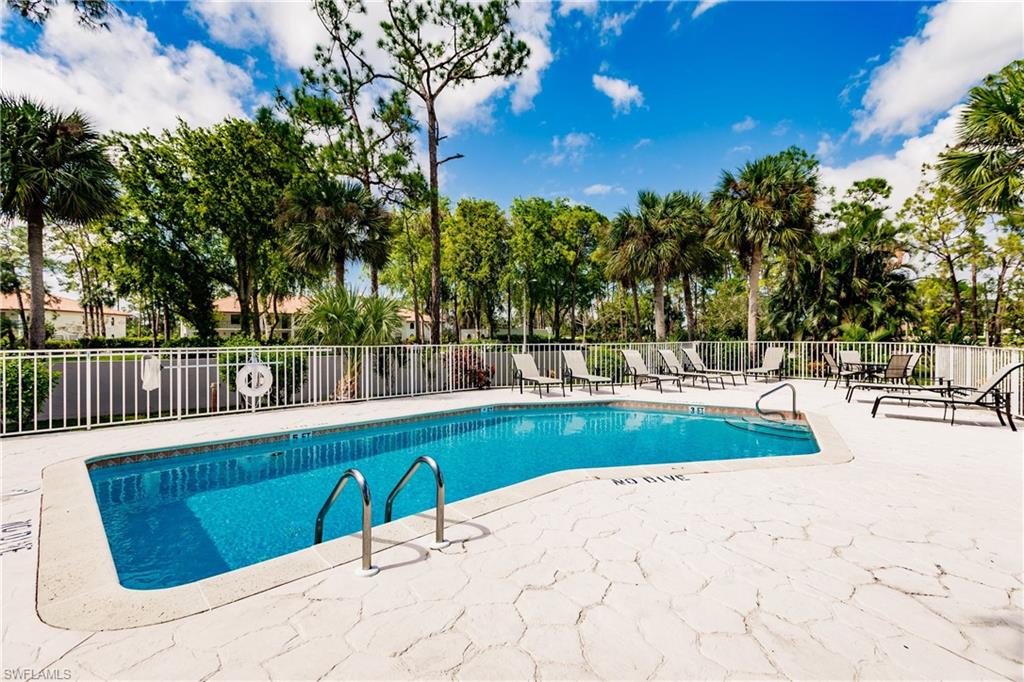 Undisclosed Address Naples, FL 34113 - Photo 24 of 24 a view of swimming pool with outdoor seating and trees in the background