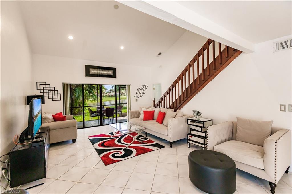 Undisclosed Address Naples, FL 34113 - Photo 3 of 24 a living room with furniture and a large window