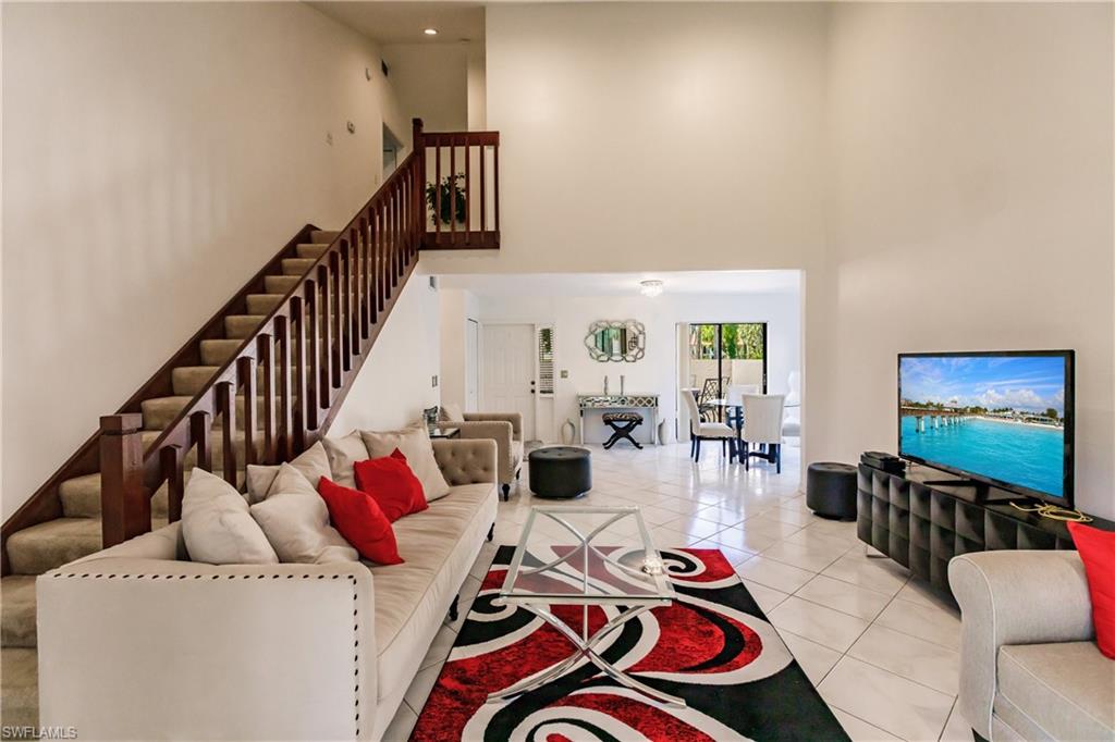 Undisclosed Address Naples, FL 34113 - Photo 5 of 24 a living room with furniture and a flat screen tv