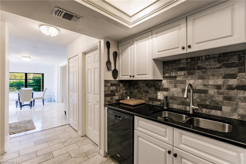 Undisclosed Address Naples, FL 34113 - Photo 9 of 24 a kitchen with a sink and cabinets