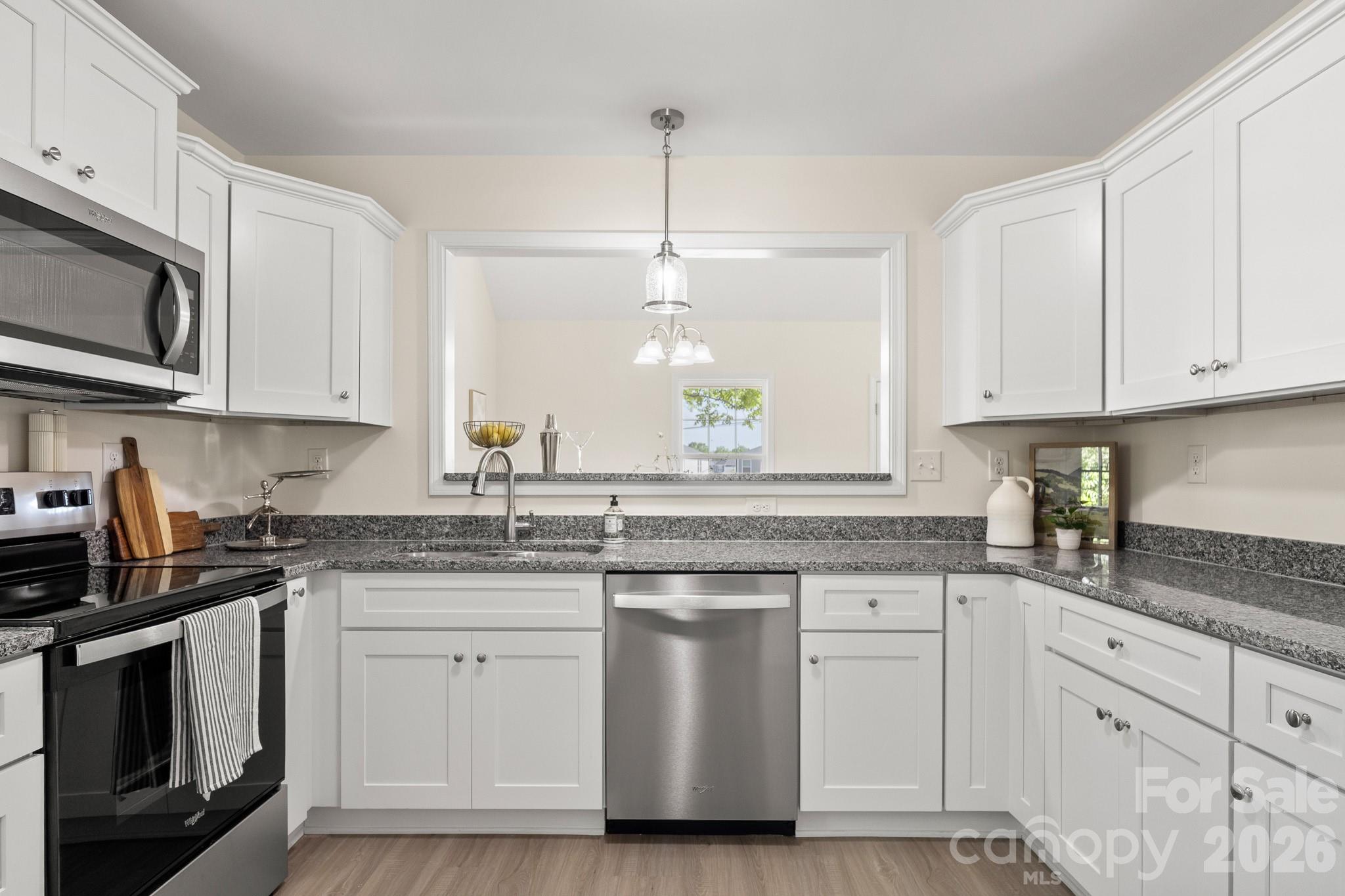 805 Hunter Street York, SC 29745 - Photo 13 of 38 a kitchen with white cabinets granite counter tops and a stove