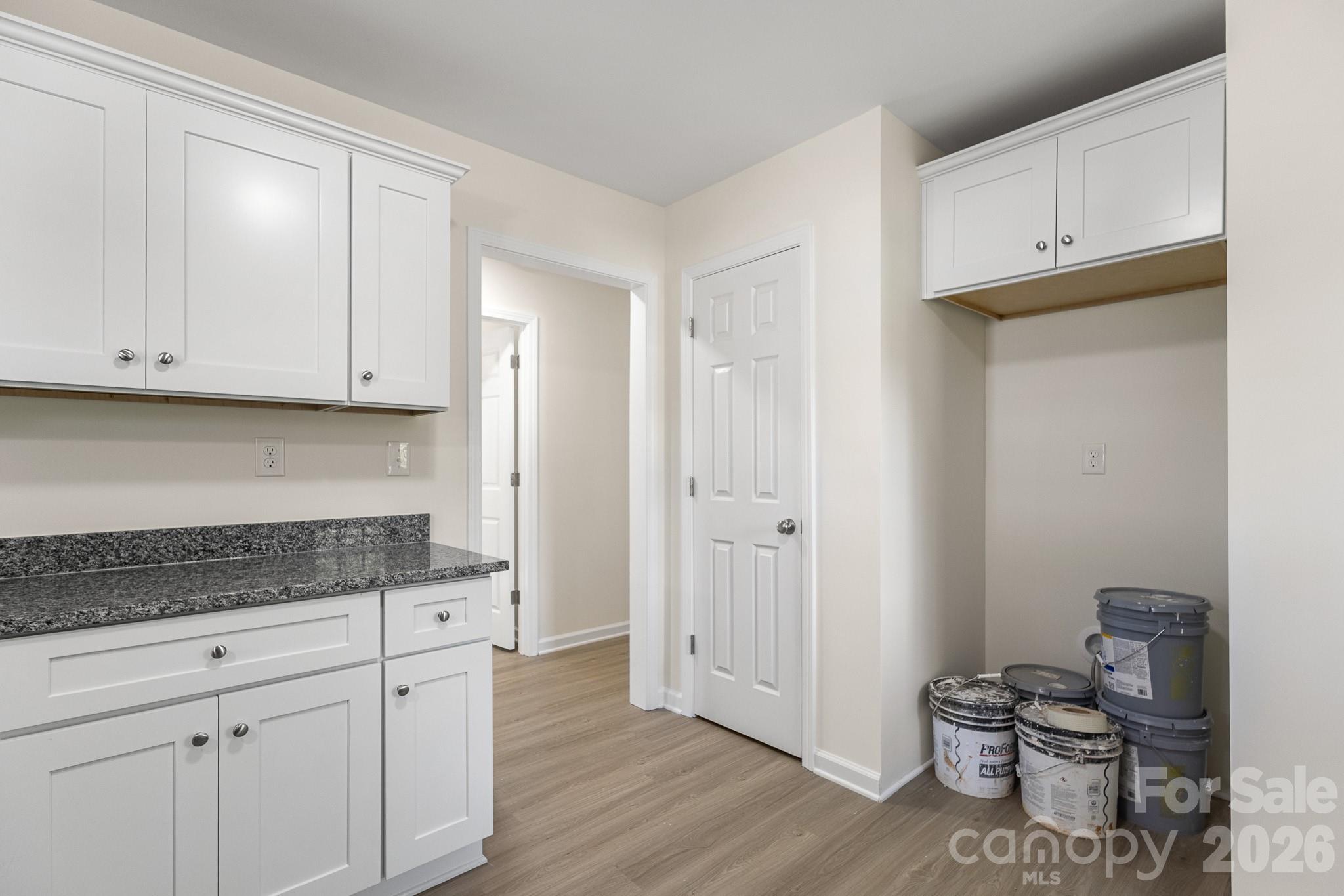 805 Hunter Street York, SC 29745 - Photo 14 of 38 a kitchen with granite countertop white cabinets and stainless steel appliances