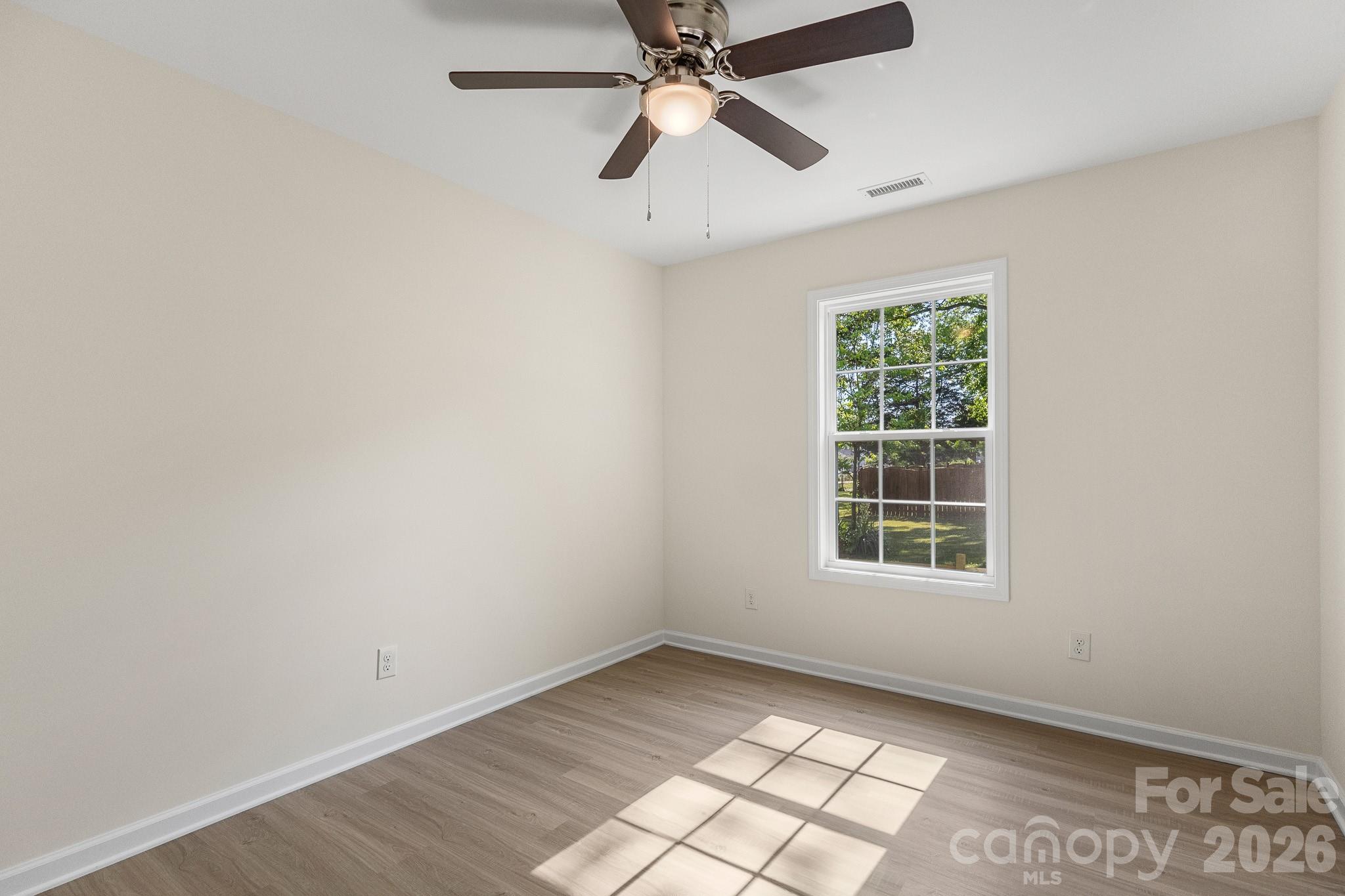 805 Hunter Street York, SC 29745 - Photo 15 of 38 an empty room with windows and fan
