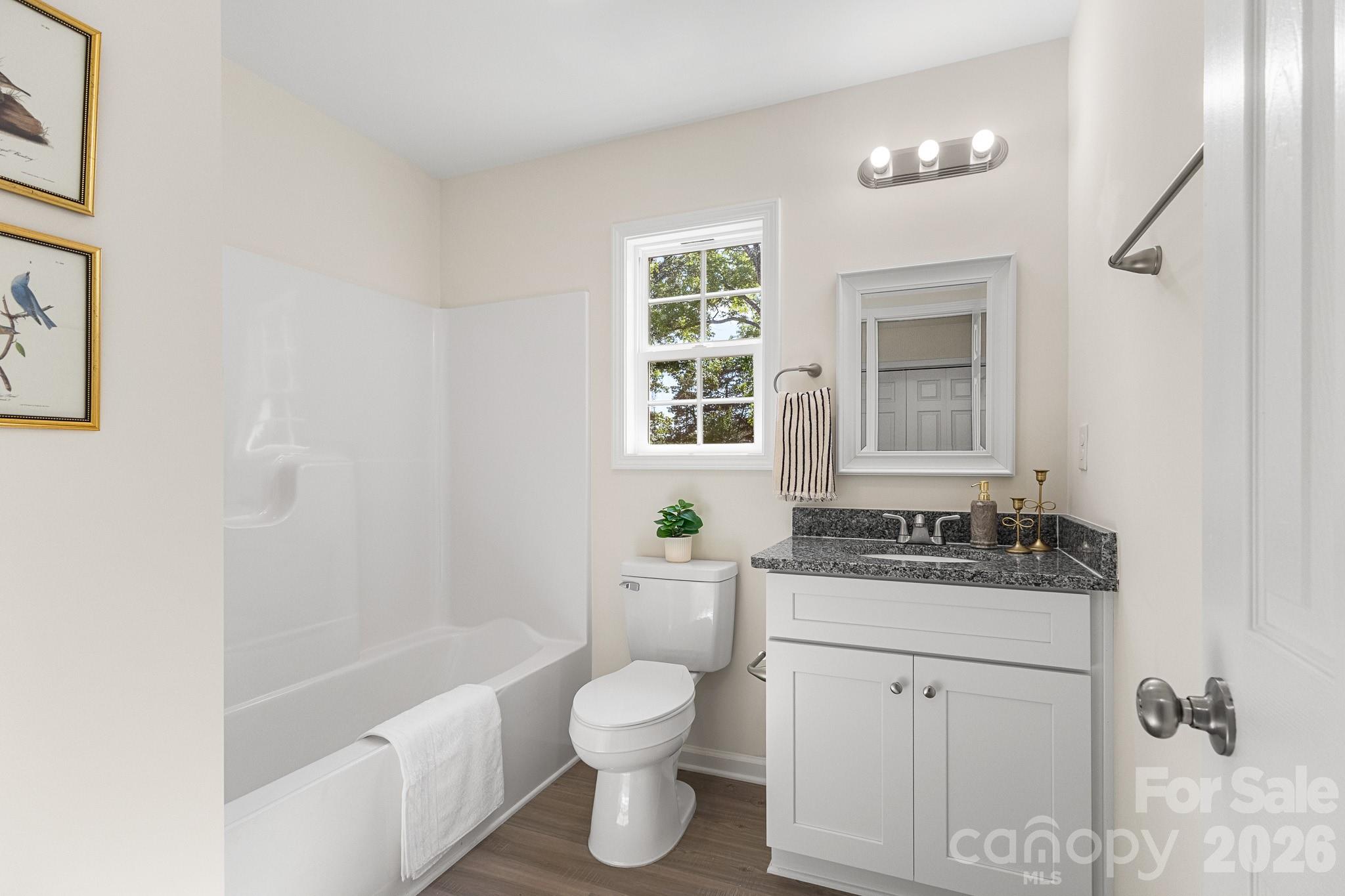 805 Hunter Street York, SC 29745 - Photo 17 of 38 a bathroom with a granite countertop sink toilet and shower