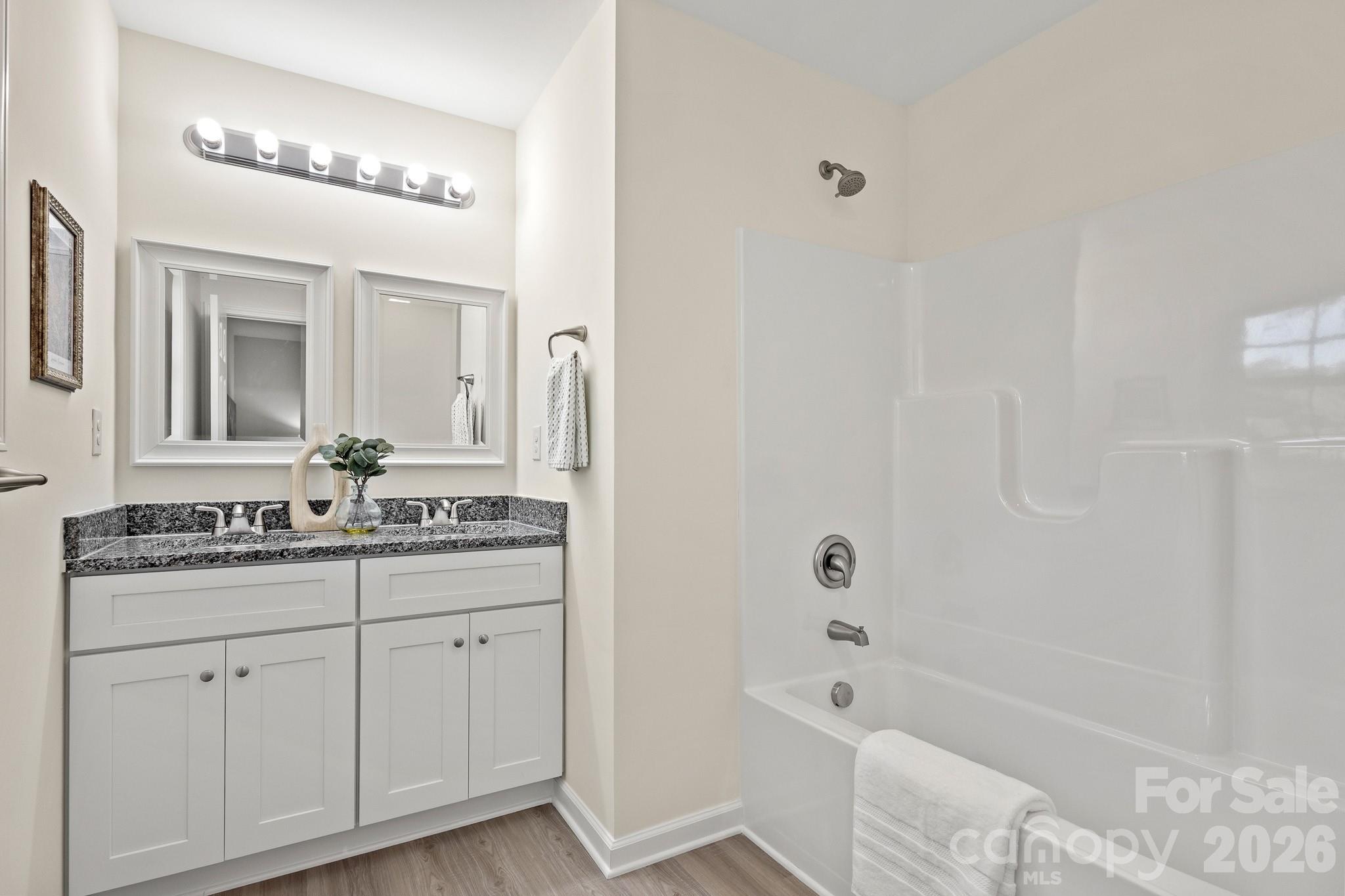 805 Hunter Street York, SC 29745 - Photo 24 of 38 a bathroom with a granite countertop sink a toilet a mirror and shower