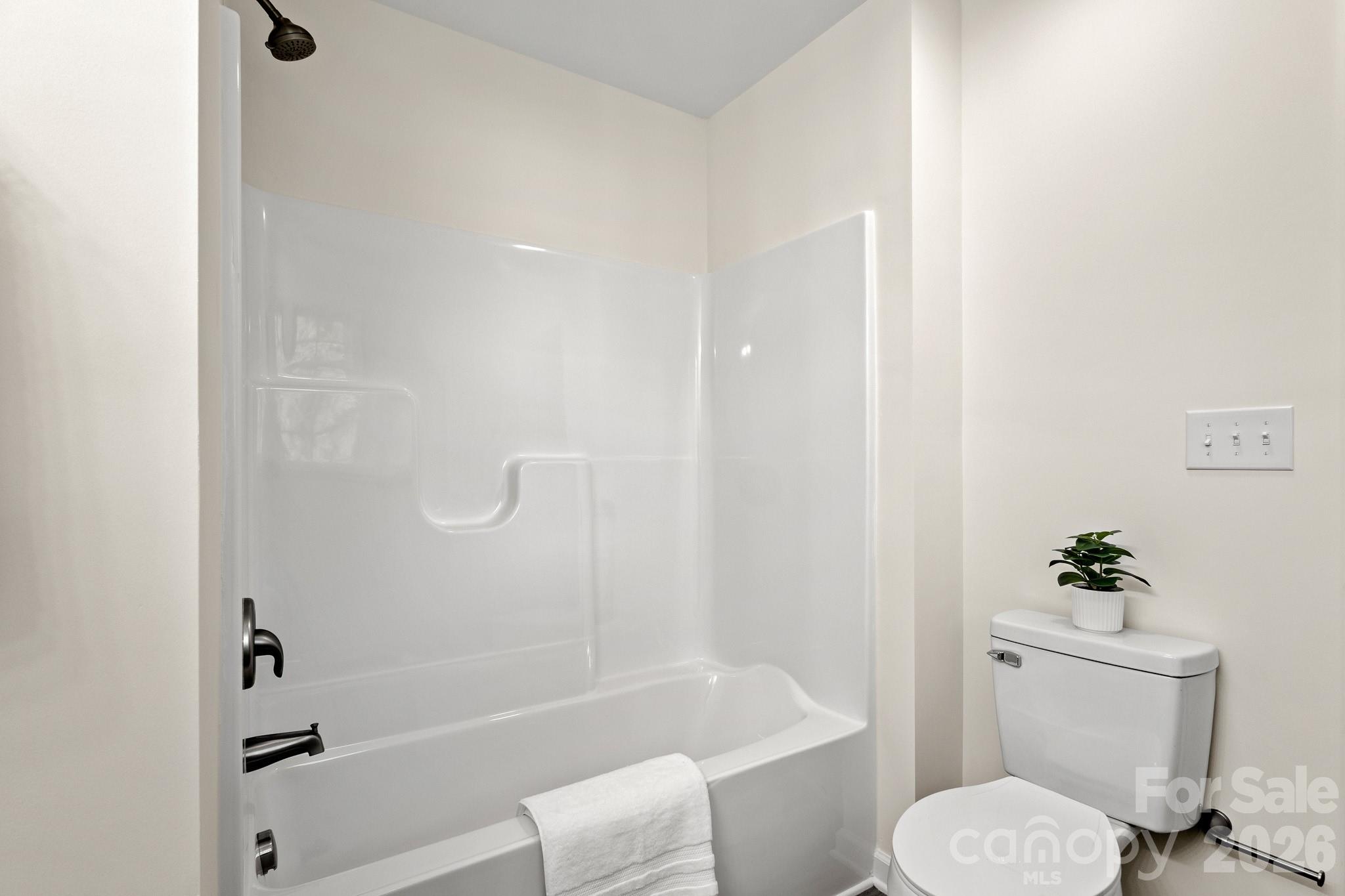 805 Hunter Street York, SC 29745 - Photo 25 of 38 a white toilet sitting next to a bath tub