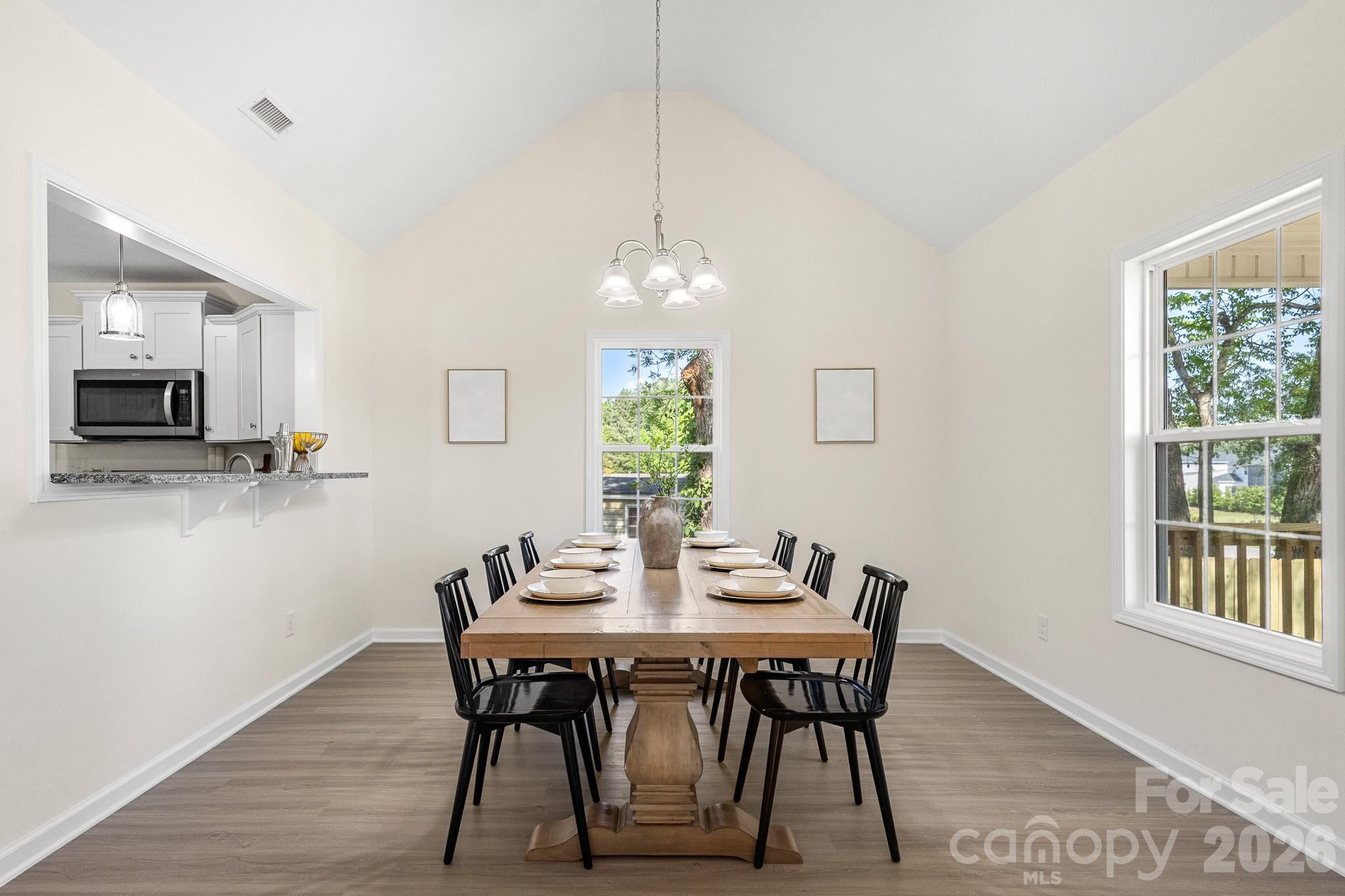 805 Hunter Street York, SC 29745 - Photo 7 of 38 a dining room with furniture a rug a potted plant and a chandelier