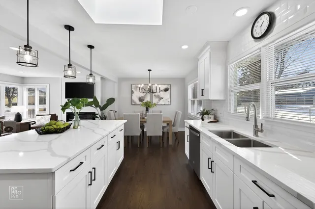a kitchen with sink stove and white cabinets