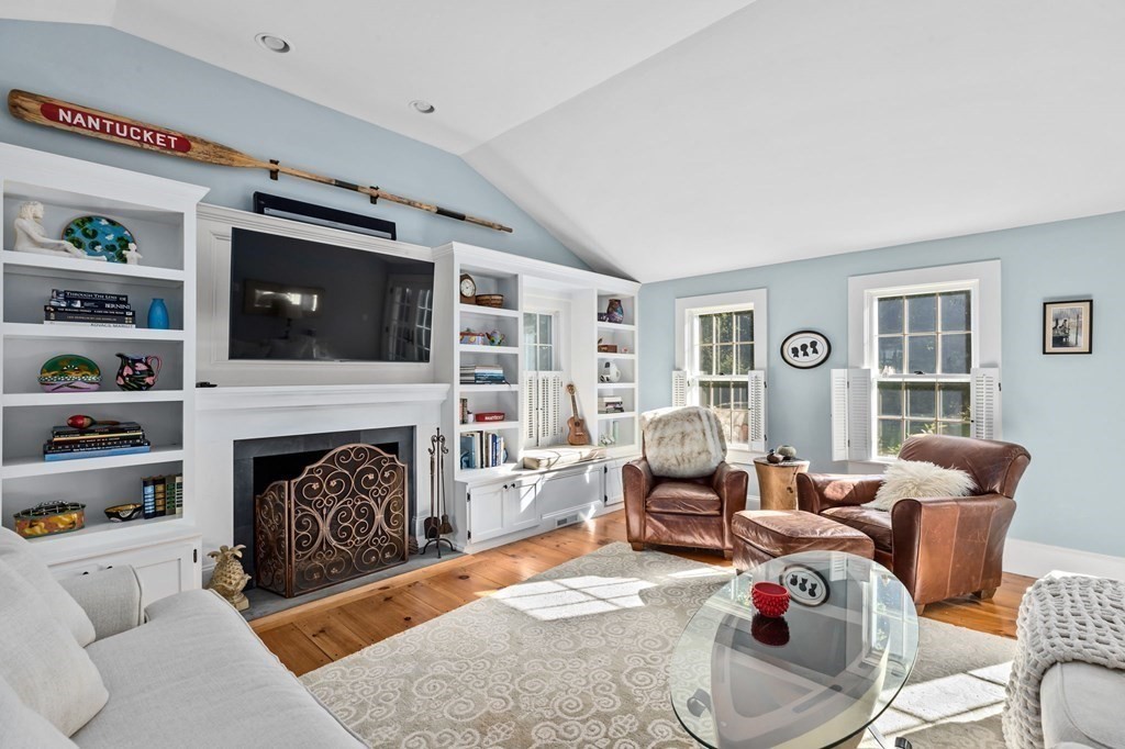 982 Main Street Hingham, MA 02043 - Photo 13 of 41 a living room with furniture a flat screen tv and a fireplace