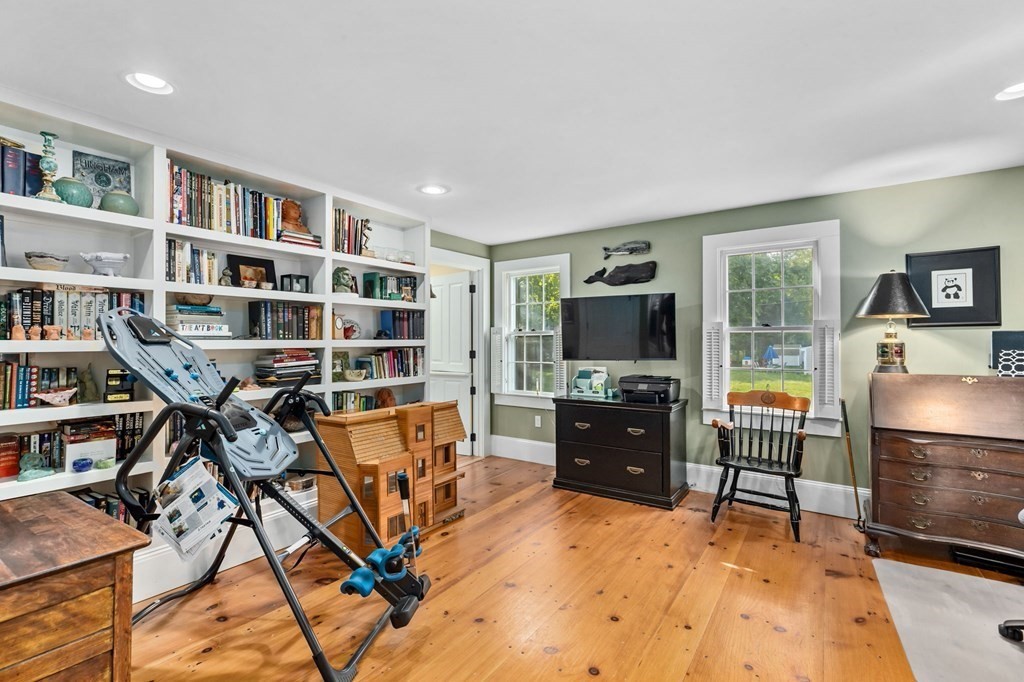 982 Main Street Hingham, MA 02043 - Photo 18 of 41 a living room with furniture a flat screen tv and a book shelf