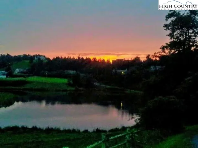 a view of a lake in middle of the sunset