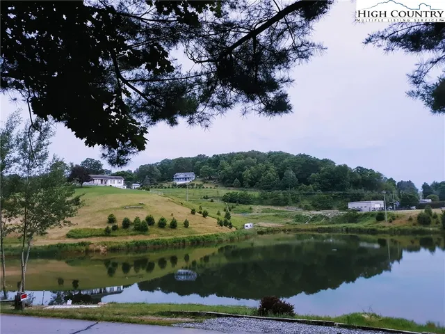 a view of a lake with houses in the back