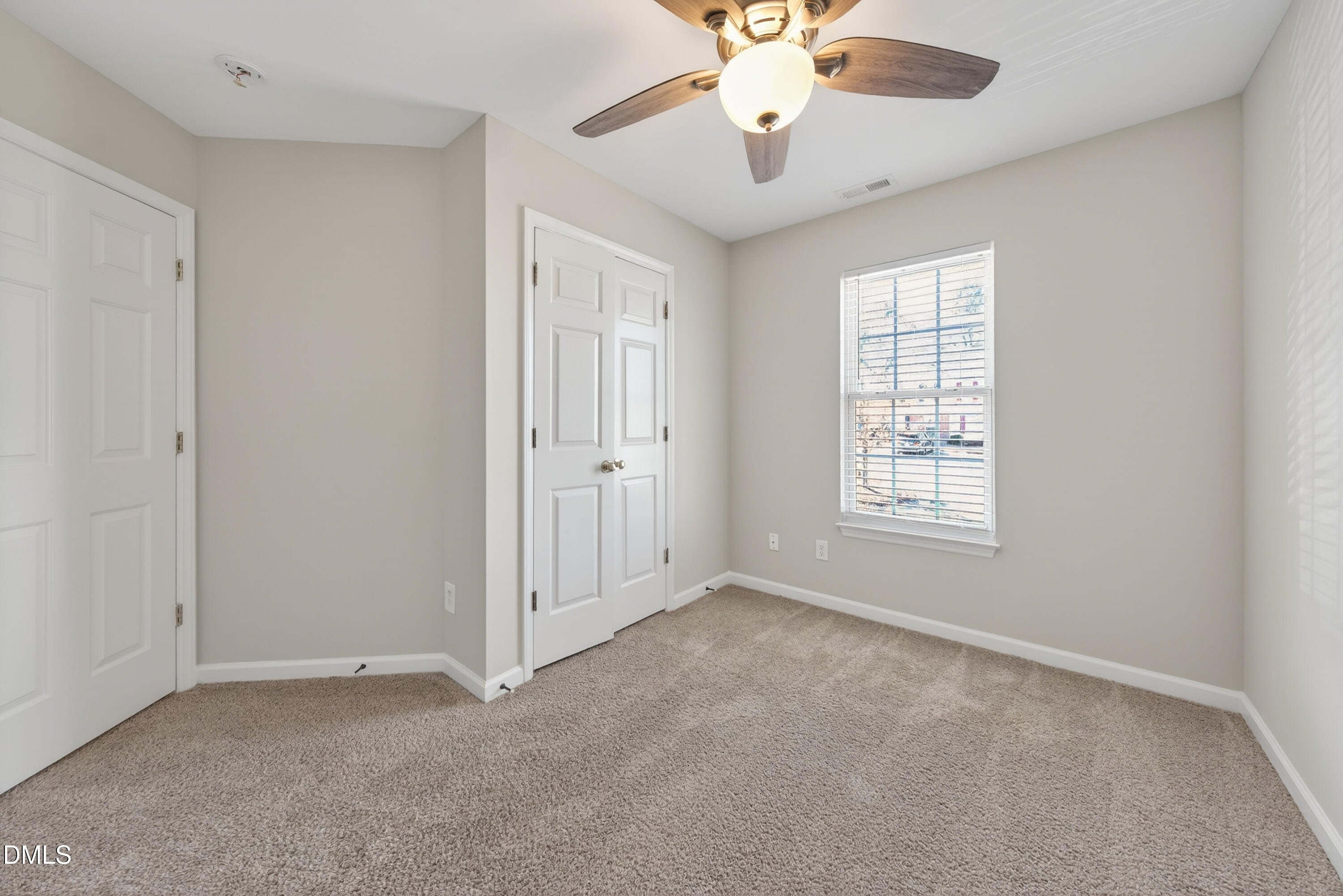 1601 Briarmont Court Raleigh, NC 27610 - Photo 20 of 30 an empty room with a chandelier fan and windows