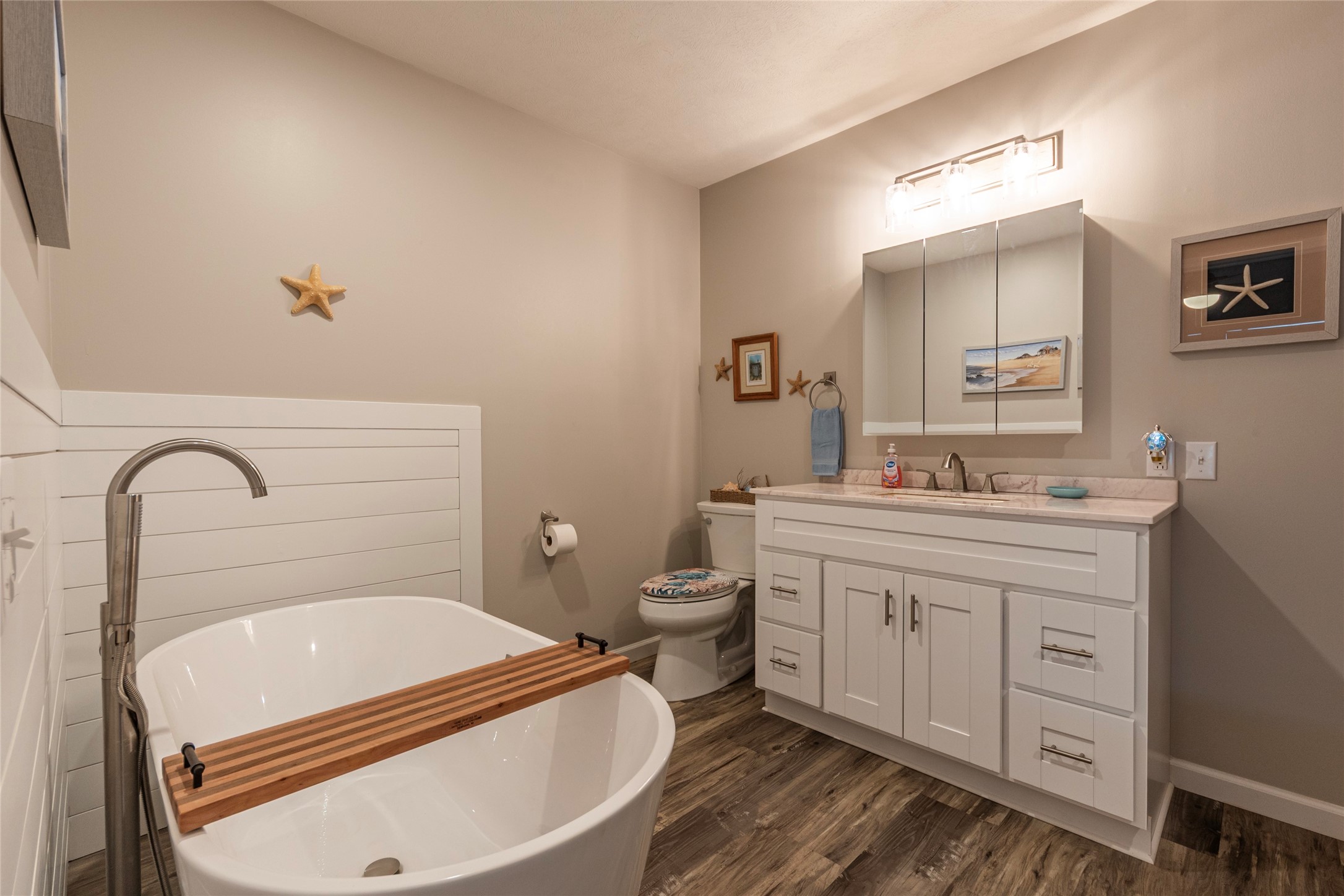 1453 County Road 230 Sargent, TX 77414 - Photo 14 of 30 a bathroom with a granite countertop toilet sink and mirror