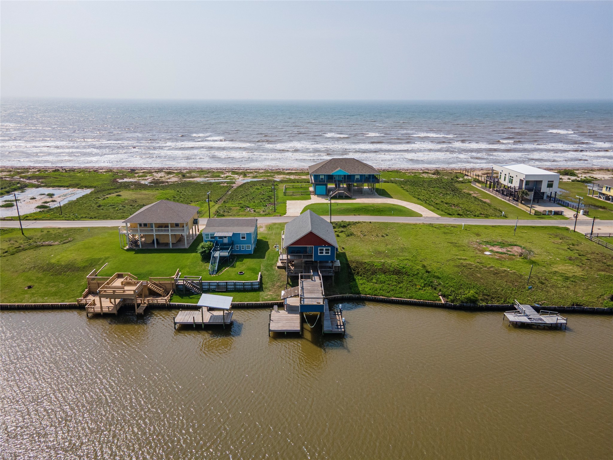 1453 County Road 230 Sargent, TX 77414 - Photo 26 of 30 an aerial view of a house with a garden and lake view