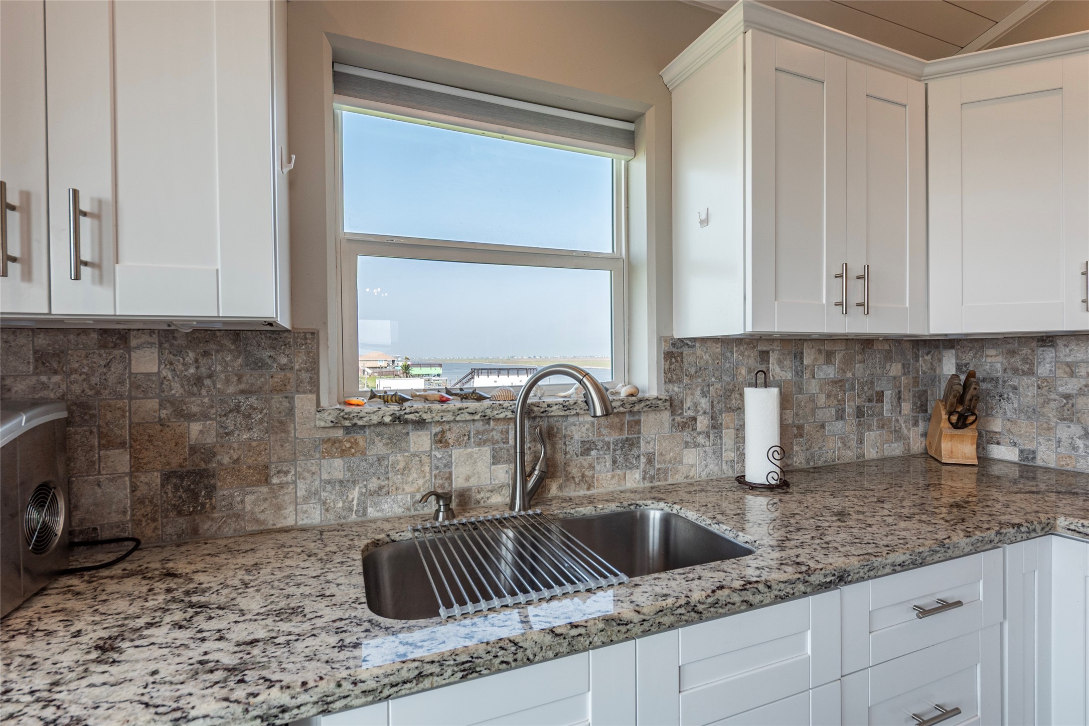 1453 County Road 230 Sargent, TX 77414 - Photo 8 of 30 a kitchen with granite countertop a sink and a stove top oven